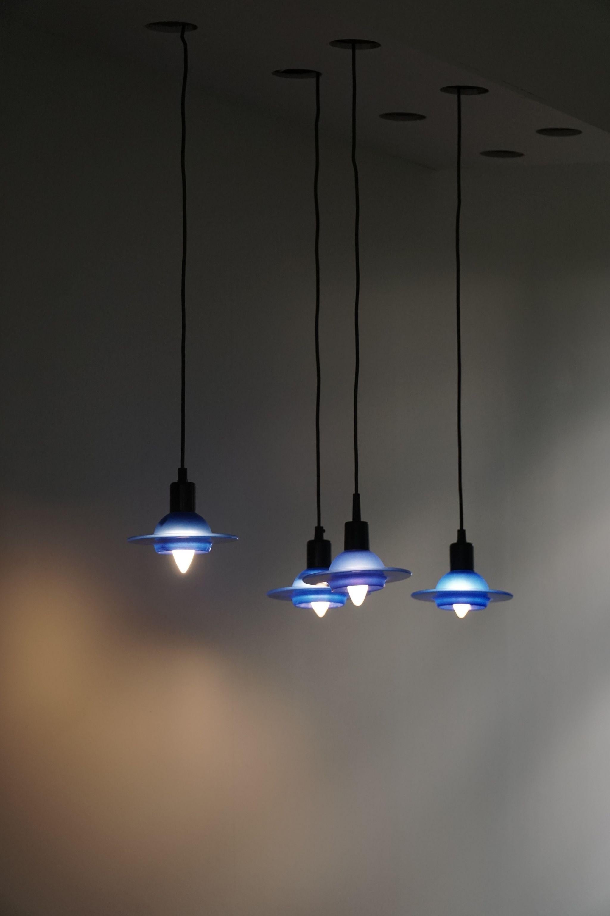 Set of 4 vintage glass lights in blue glass. Made by Design Light A/S, Denmark, in the 90s. These have gone out of production today. A cosy light, perfect for a kitchen, a comfortable corner or a set over the dining table.

The overall impression