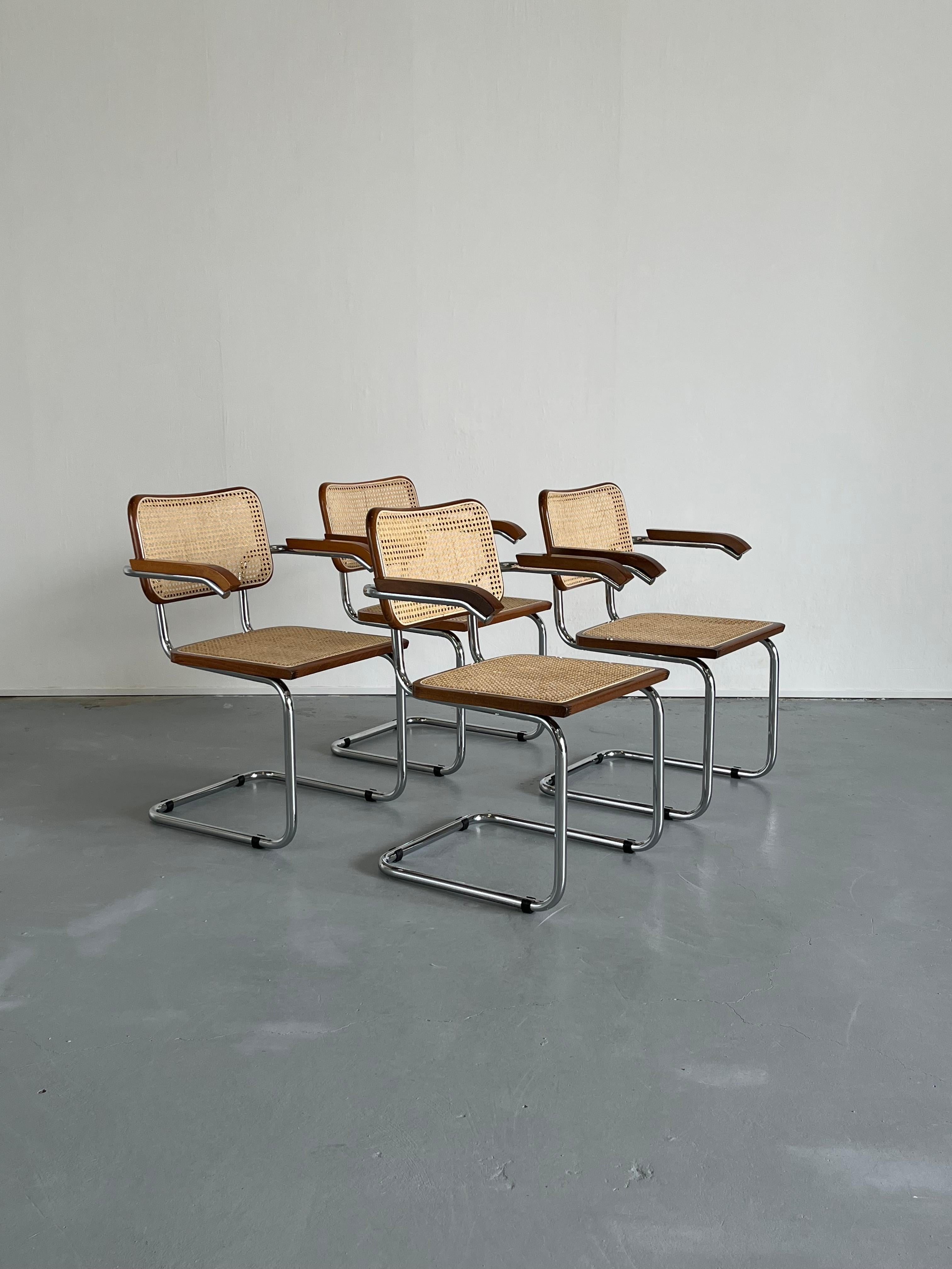 A set of four beautiful vintage Marcel Breuer design B64 cantilever chairs with armrests, in a rare lacquered walnut brown finish.
Completely original parts, and in original vintage condition. 

Vintage 1980s or 1990s Italian