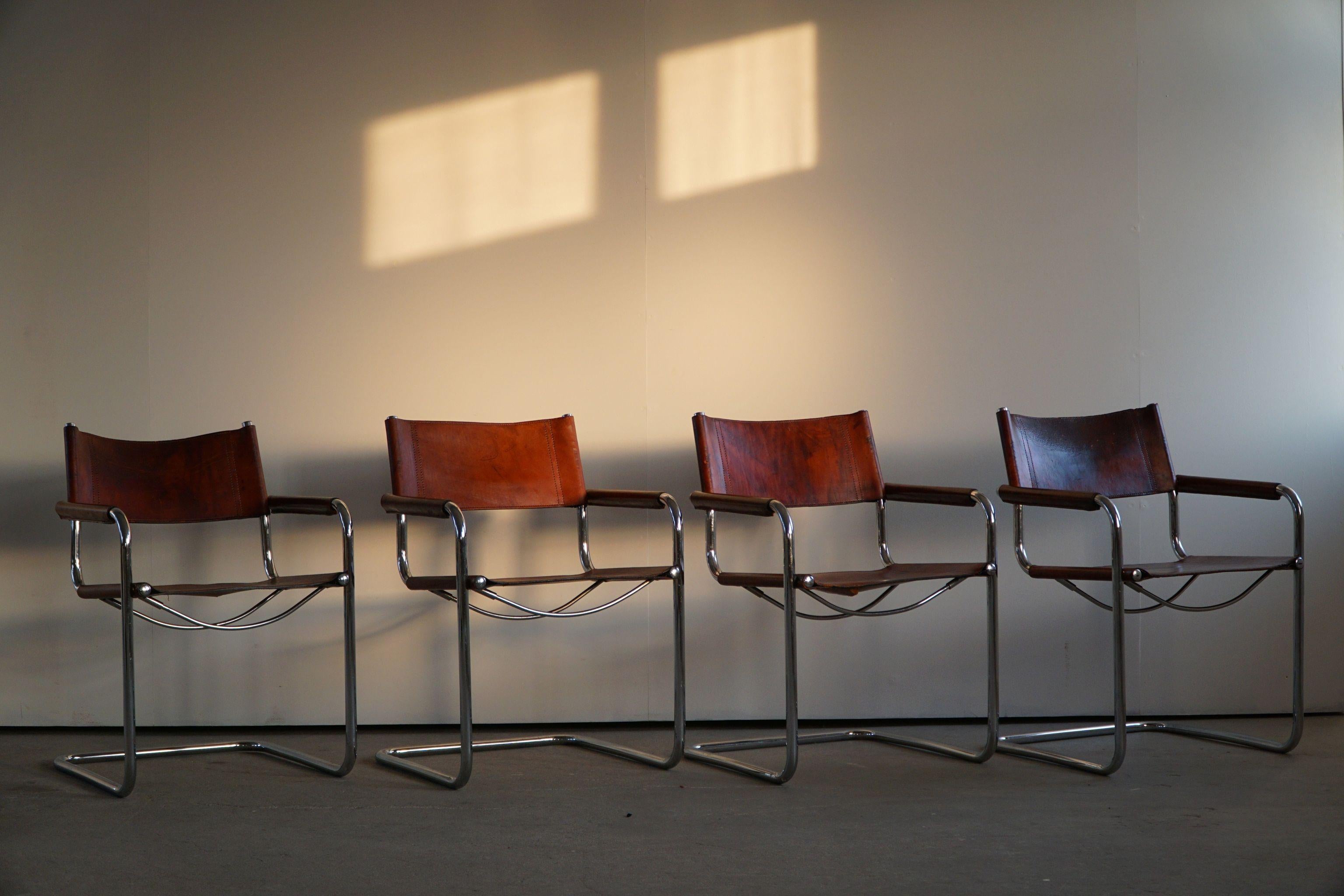 Set of 4 Vintage cantilever armchairs in patinated orange / cognac leather by Linea Veam, made in Italy, 1970s. The chairs are strongly reminiscent of bauhaus works by Mart Stam and Marcel Breuer. 

A nice set perfectly suited for many interior