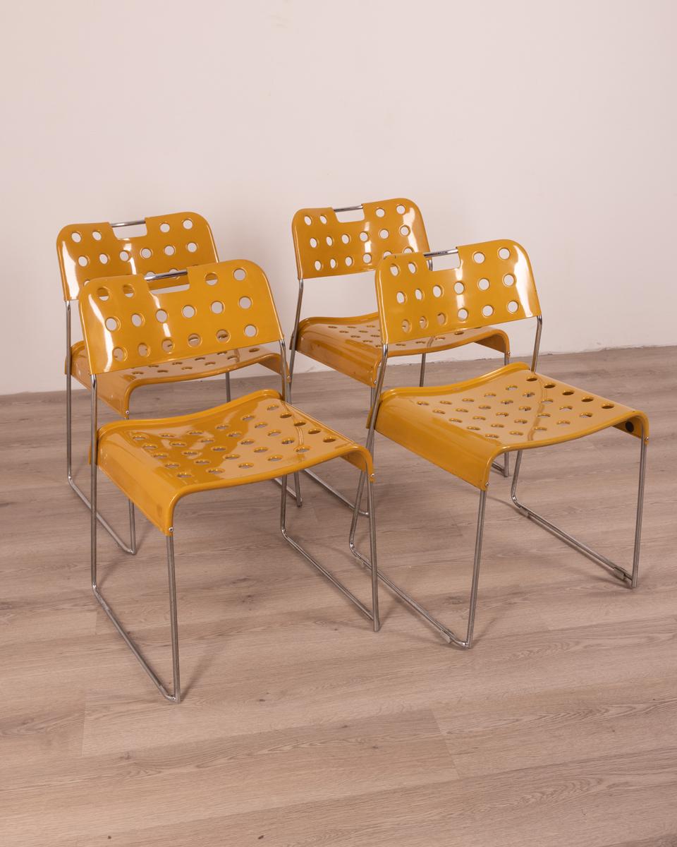 Set of four chairs with chromed steel structure and Yellow metal seat and back.
Omkstack model, design Rodney Kinsman for Bieffeplast, 70s.

Condition: In good condition, showing signs of wear.

Dimensions: Height 75 cm; Width 46cm; Depth
