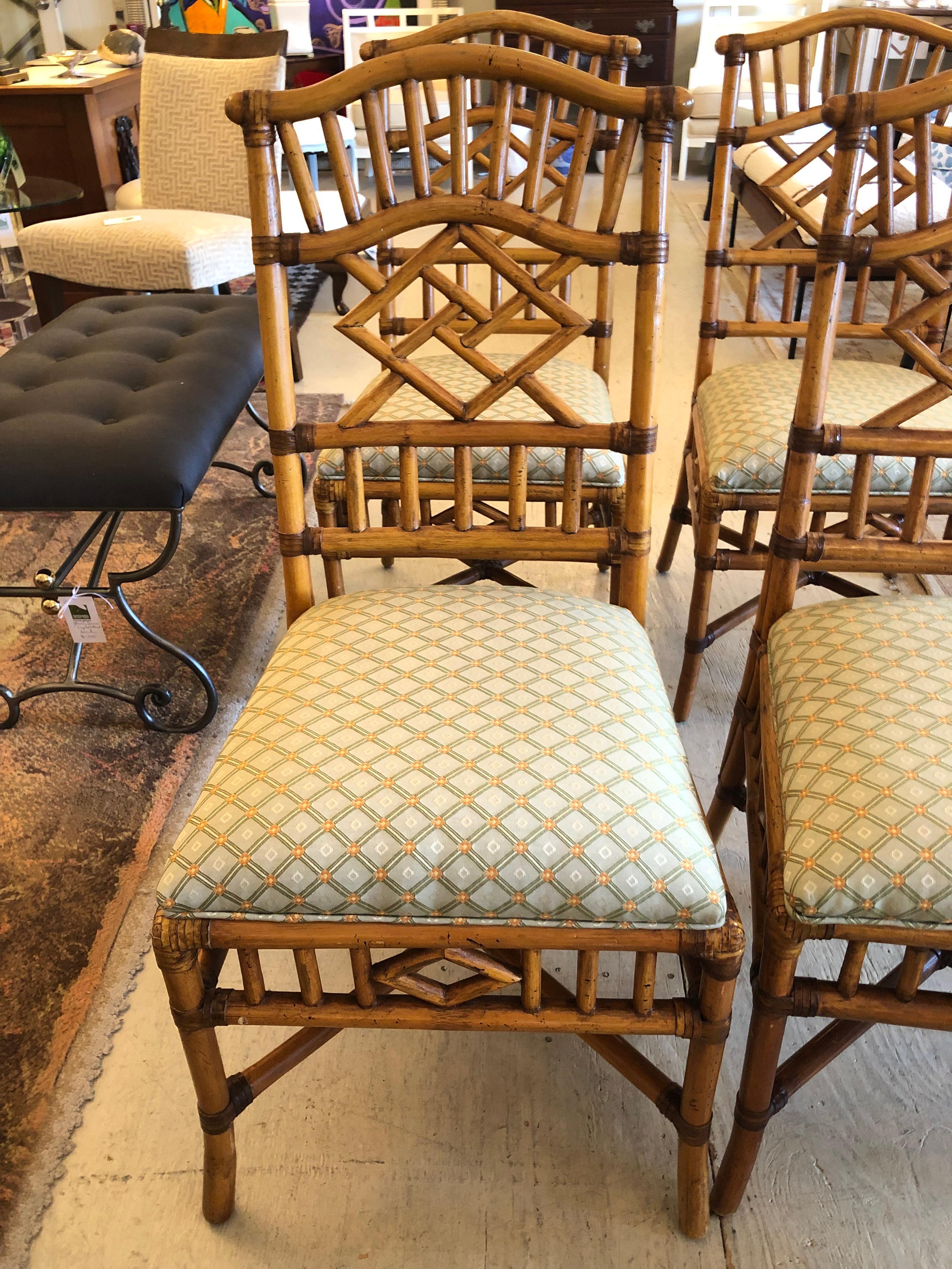 Stylish set of 4 mid century honey rattan dining chairs having beautiful lattice design with diamond shapes intermingled, beautiful front and back.  There are newly upholstered attached seats.  Very solid and well made.