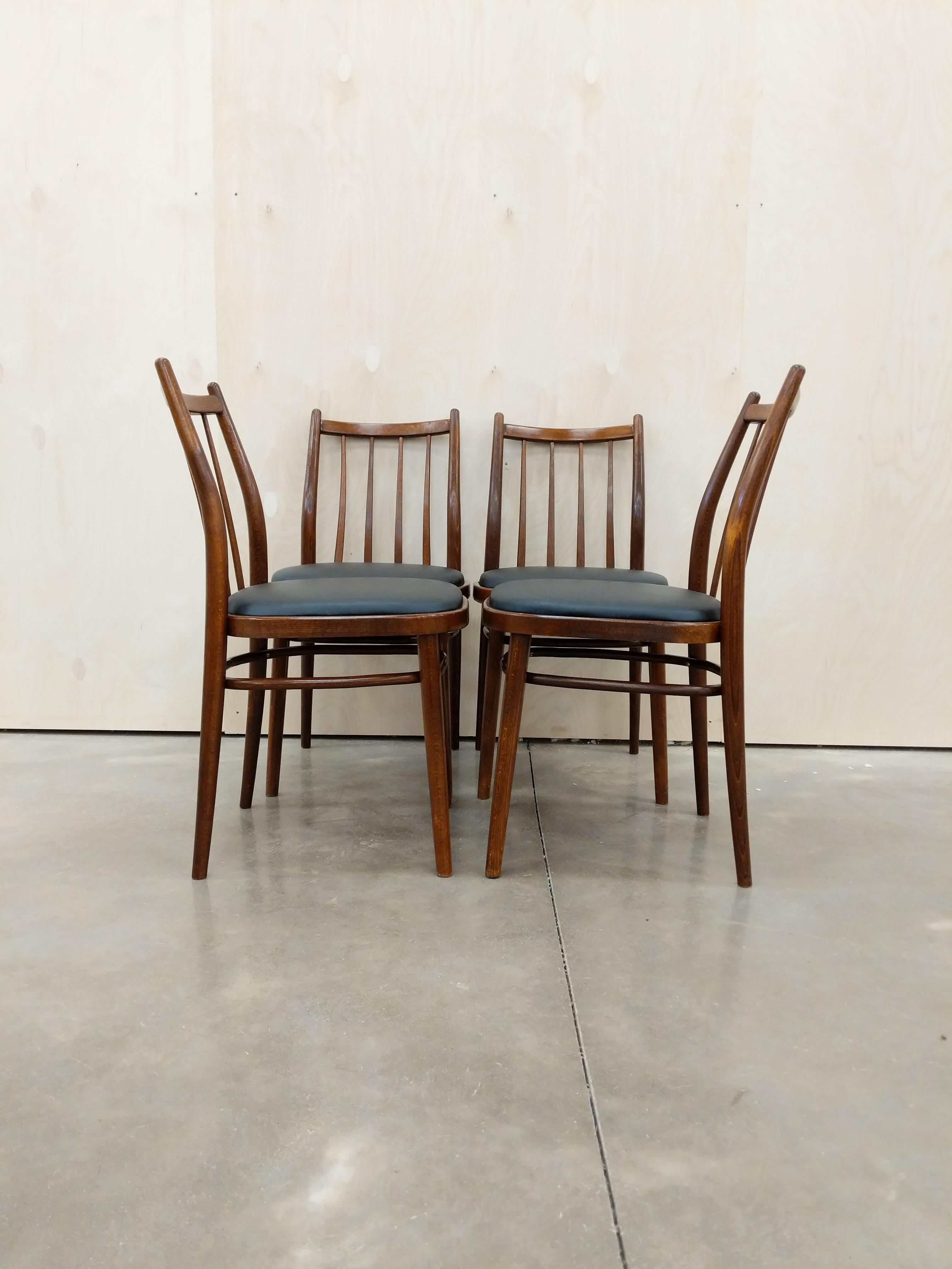 Set of 4 authentic vintage Czech mid century modern dining chairs.

By UP Zavody Rousinov. Maker's label on bottom.

This set is in excellent vintage condition with brand new upholstery (see photos).

If you would like any additional details, please