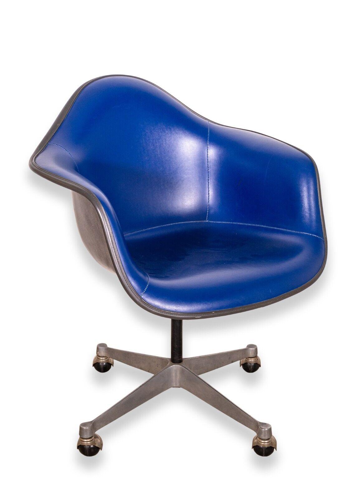 A set of 4 vintage Eames Herman Miller molded fiberglass blue leather padded swivel chairs. A lovely set of classic mid century Herman Miller Chairs. These chairs feature a timeless molded fiberglass seat, a rich, blue leather coloring, comfortable