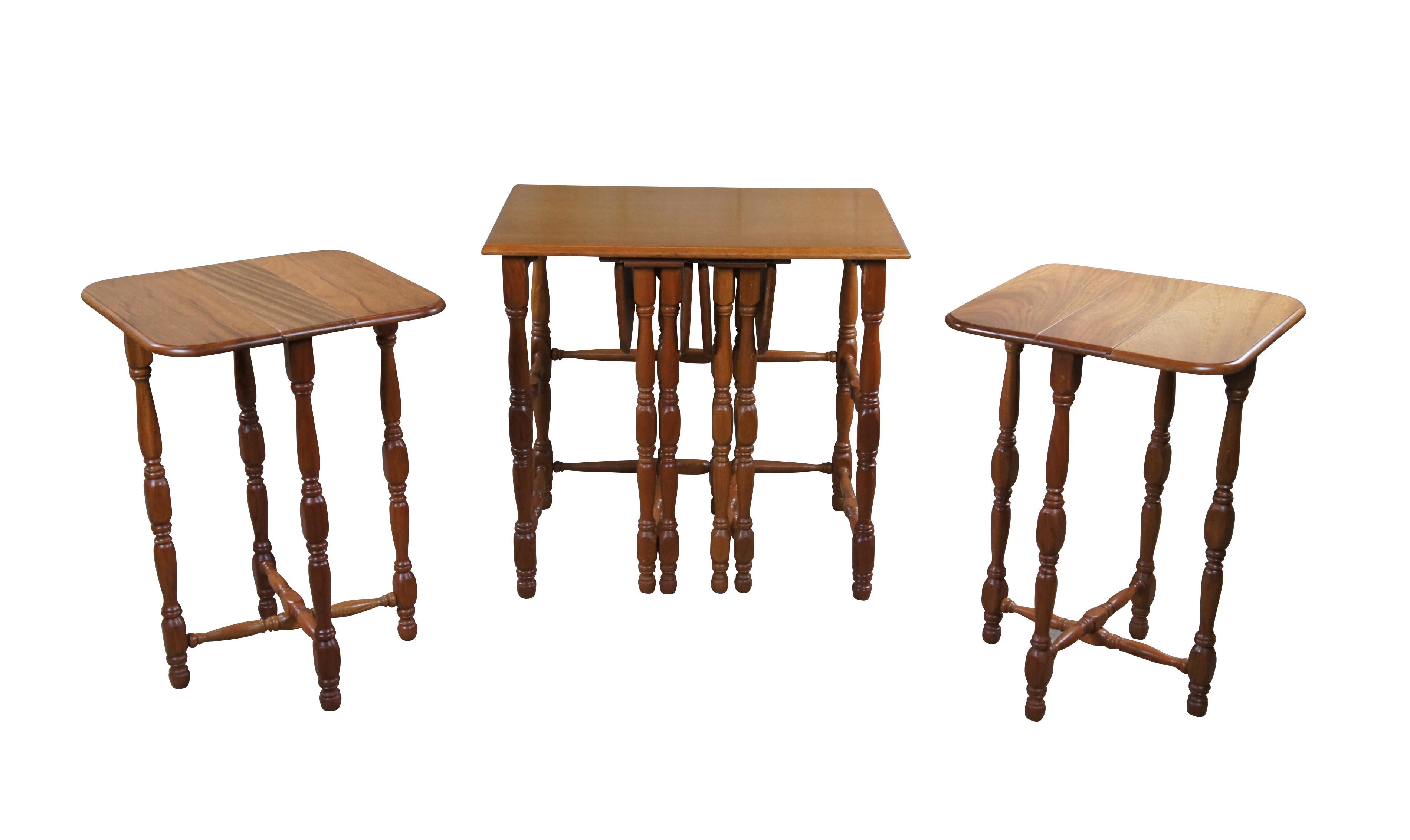 Intriguing set of farmhouse nesting tables. Made from oak with a carrier or larger side table that houses each of the four drop leaf nesting tables.   Nesting tables. Features turned legs and X formed base when opened.

Dimensions:
25