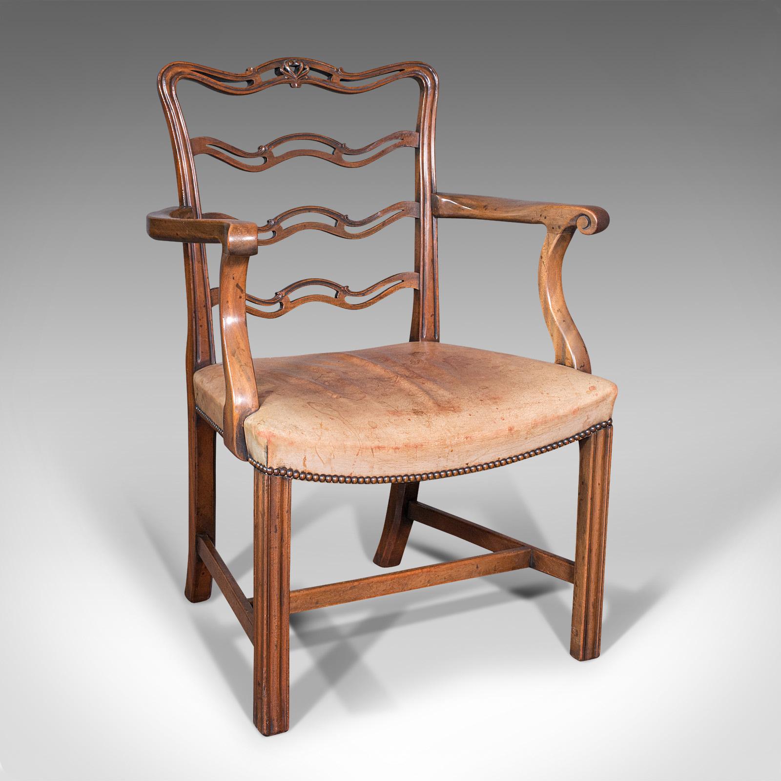 This is a set of four vintage ladder back chairs. An Irish, mahogany carver and seat, dating to the Art Deco period, circa 1940.

Resplendent in Irish Chippendale revival taste
Generously wide in profile, affording comfortable seating
Displaying