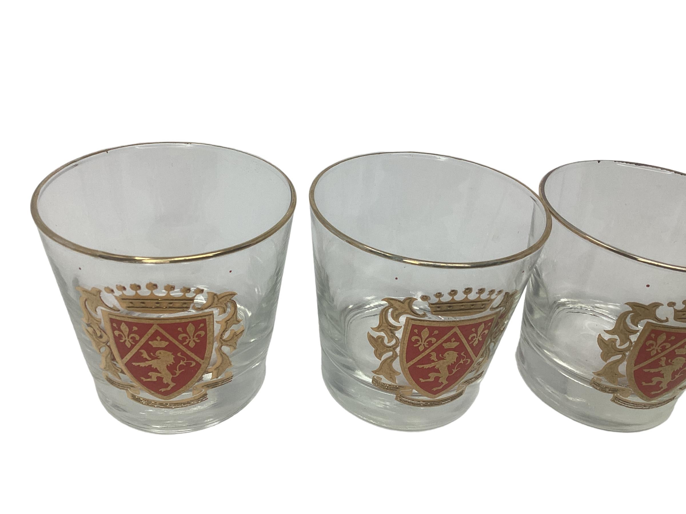 Set of 4 Vintage Libbey Rocks Glasses with Rampant Lions. Each glass is rimmed in 22k gold with a bold red shield and a rampant lion and fleur de lis, topped with a gold crown.