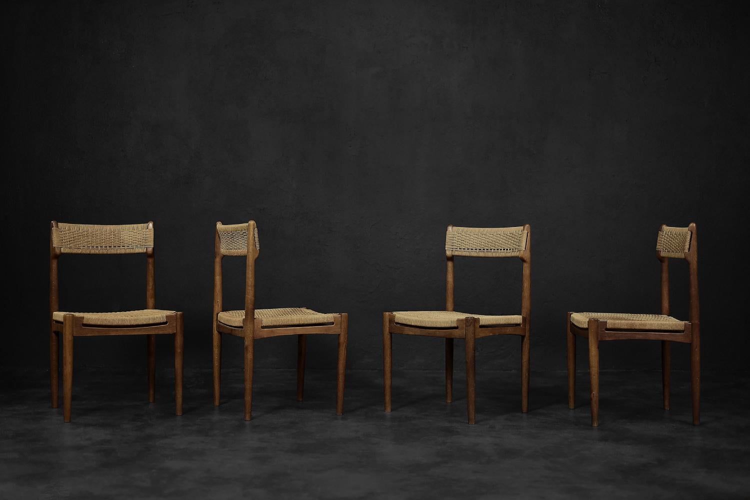 This set of four modernist chairs was designed by E. Knudsen and made by the Danish furniture manufacturer K. Knudsen & Søn in 1952. This model was exhibited for the first time at the congress in Federica, where it was designed. The frame is made of