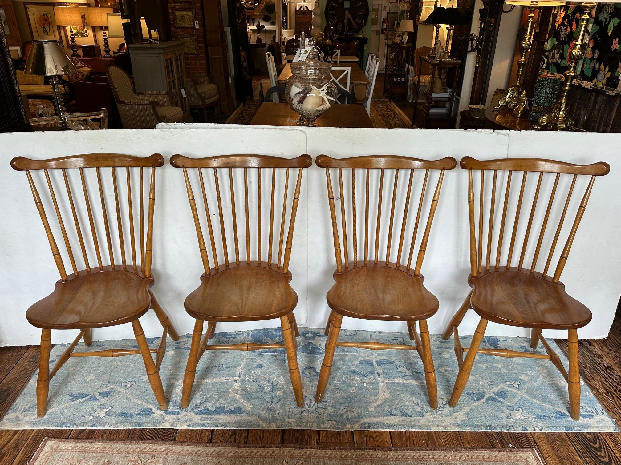 Classic set of vintage walnut Stickley fan back Windsor dining chairs having spindle backs, turned legs and sturdy construction.