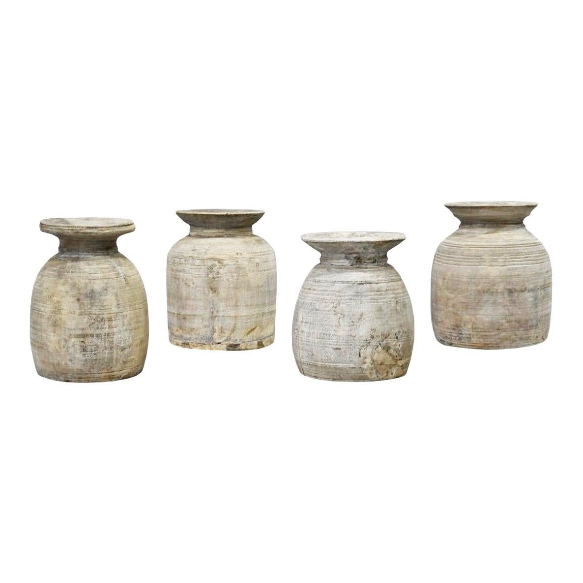A beautiful set of four turned wood pot vases. Each one is uniquely made and they vary in 14