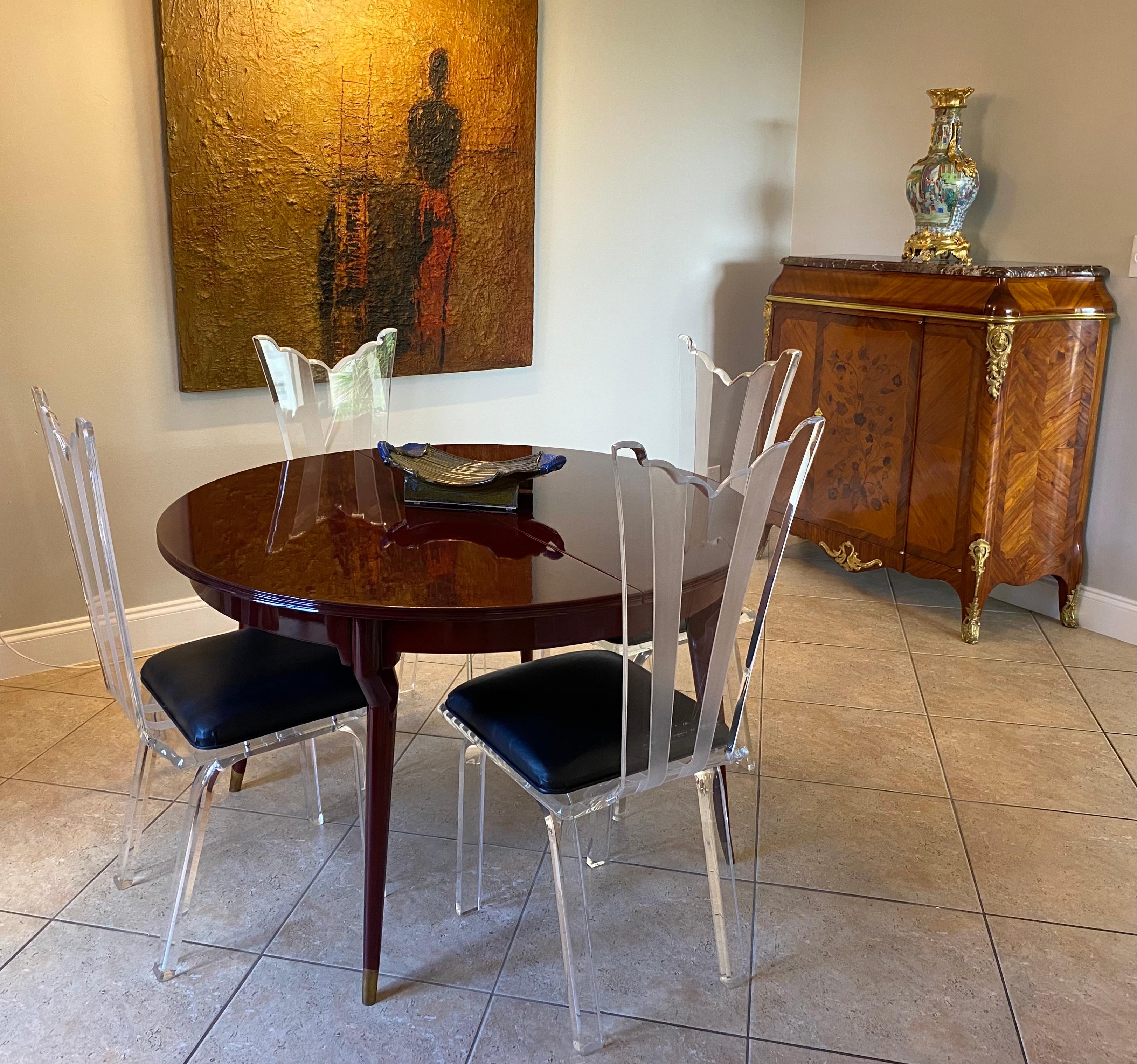 Set of four vintage stylish 1980s Lucite dining chairs attributed to Neal Small.

Elegant design with contoured profile to the back supports and legs. The back support is embellished with two bands of frosted acrylic running vertically. The top of