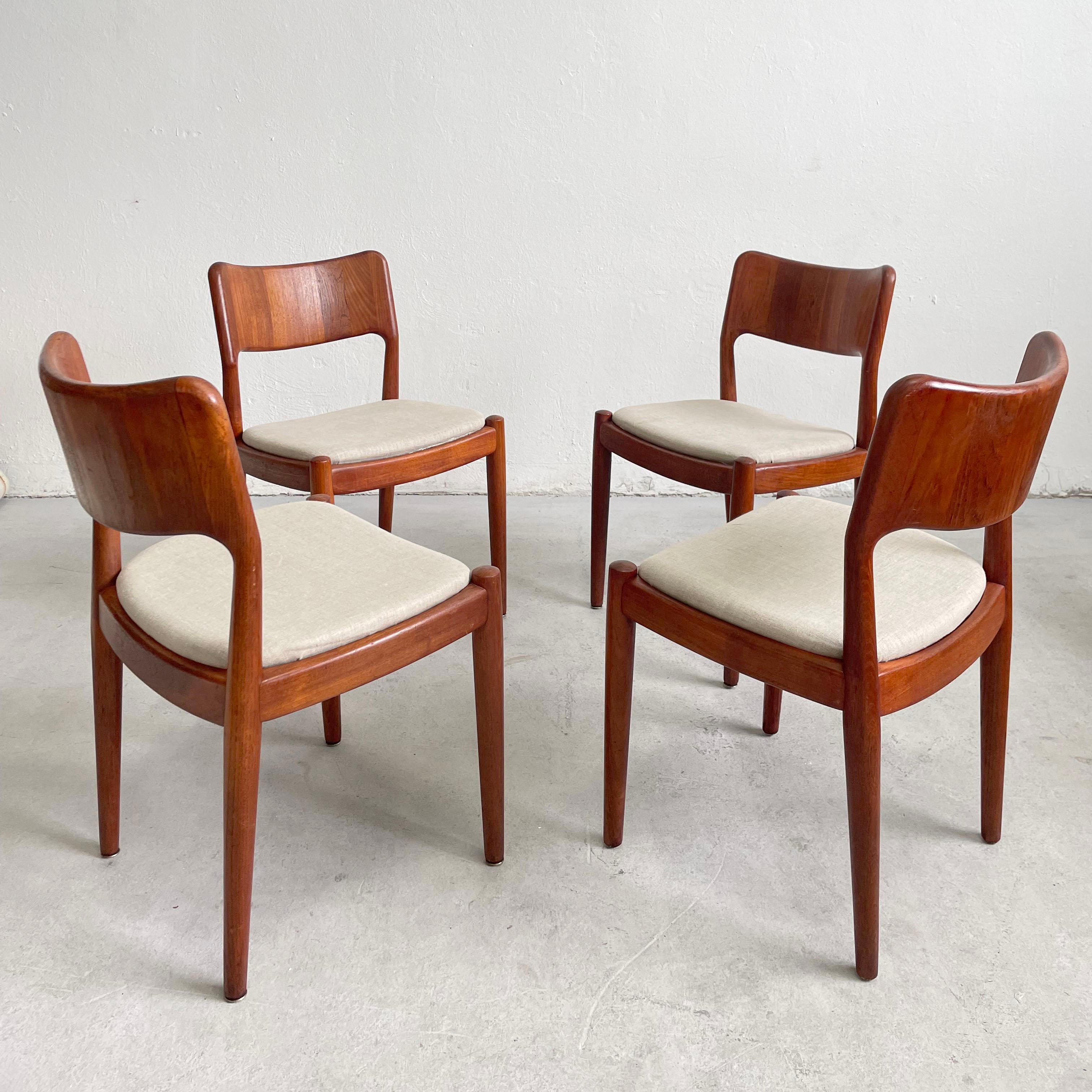 Set of four Danish modern chairs manufactured by the Danish manufacturer Glostrup Møbelfabrik during the 1960s. 

The chairs are made of solid teak in a warm shade of brown that shows beautiful rich wood grain. The seat is upholstered with a grey