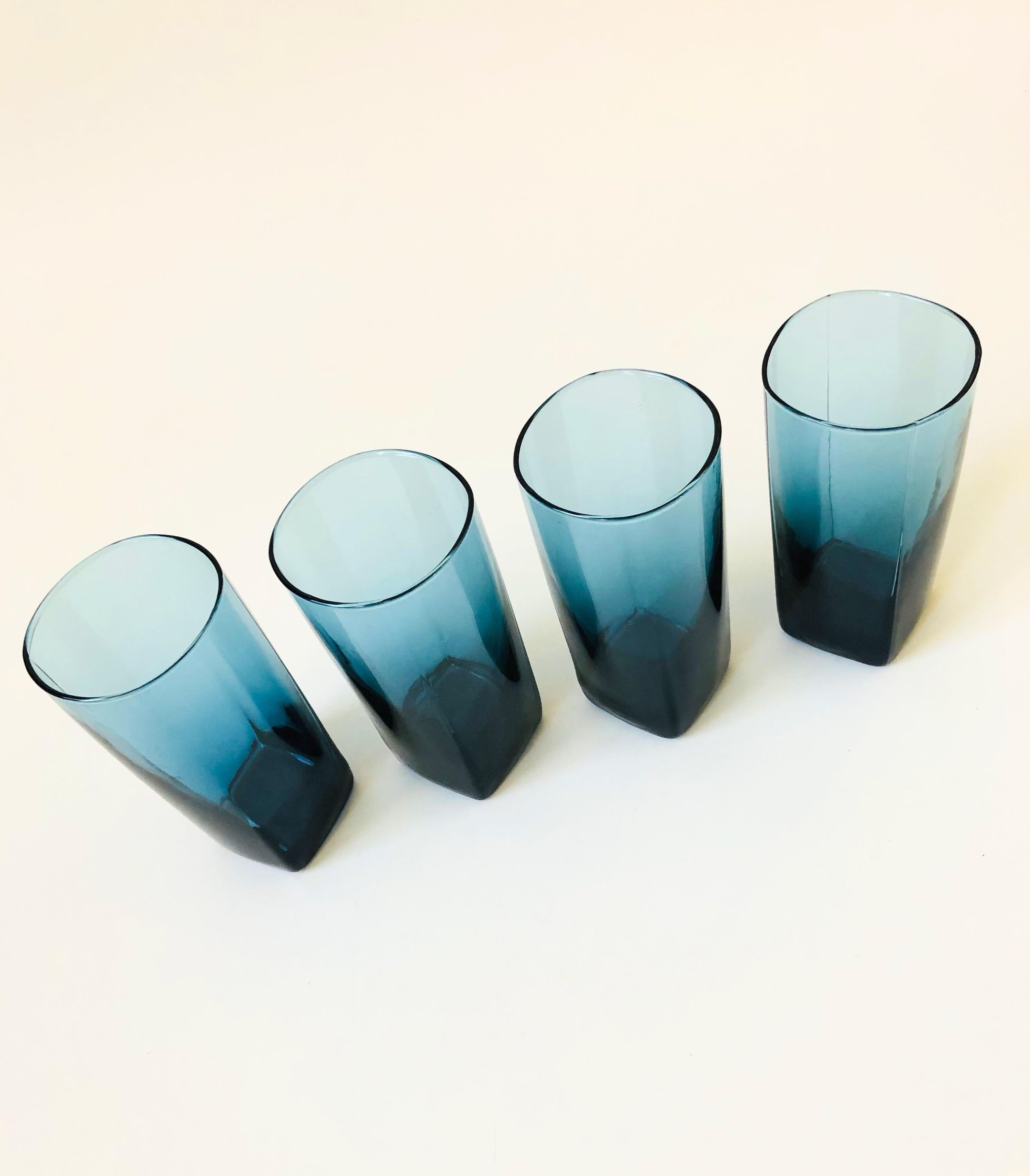 A set of 4 vintage highball glasses in moody dark blue glass. Nice slightly squared shape and thickening of the glass at the base. Perfect for using as water glasses or for cocktails.
   