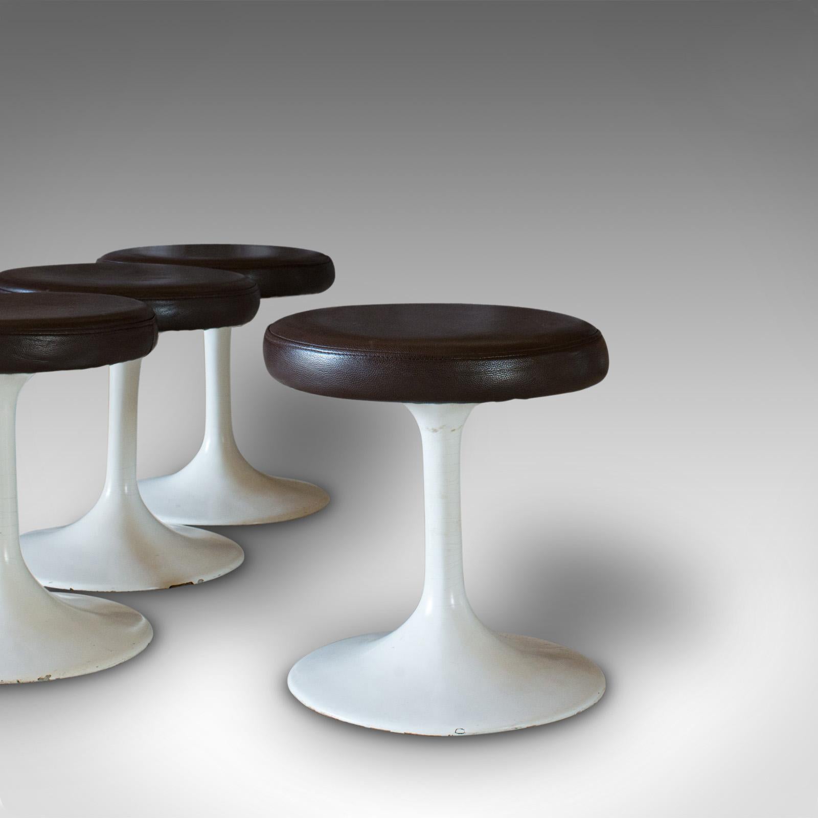 This is a set of 4, vintage stools. A French, leather cushioned pedestal stool, dating to the mid-20th century, circa 1960.

A charming, vintage set
Displays a desirable aged patina
Quality leather with double-stitched seams

Comfortable, soft