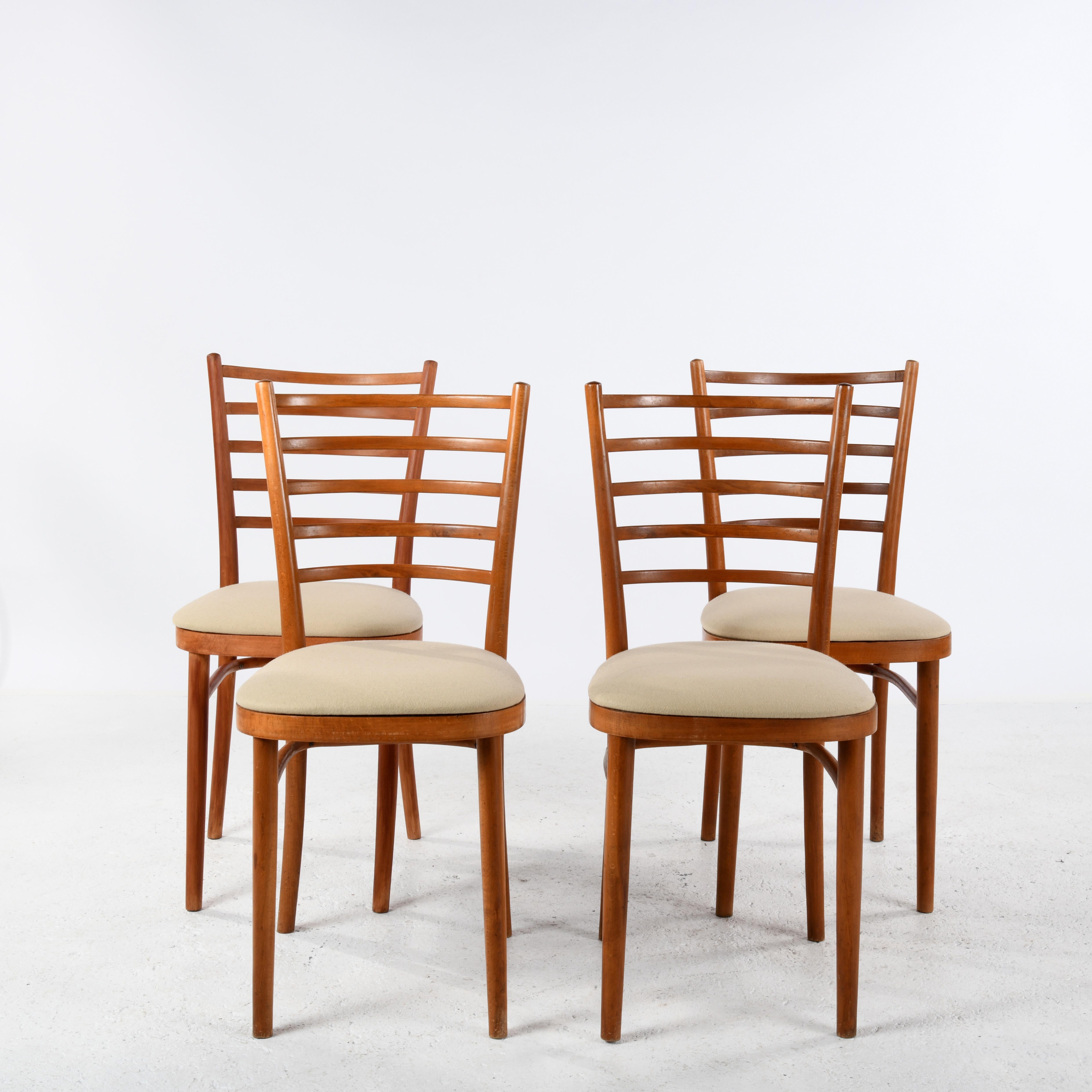 Suite of 4 bent beechwood chairs made by Thonet between 1922 and 1940. Thin, light and elegant, they have been overhauled and are in good mechanical condition. These chairs have been reupholstered in 100% pure wool. A Thonet paper label is still