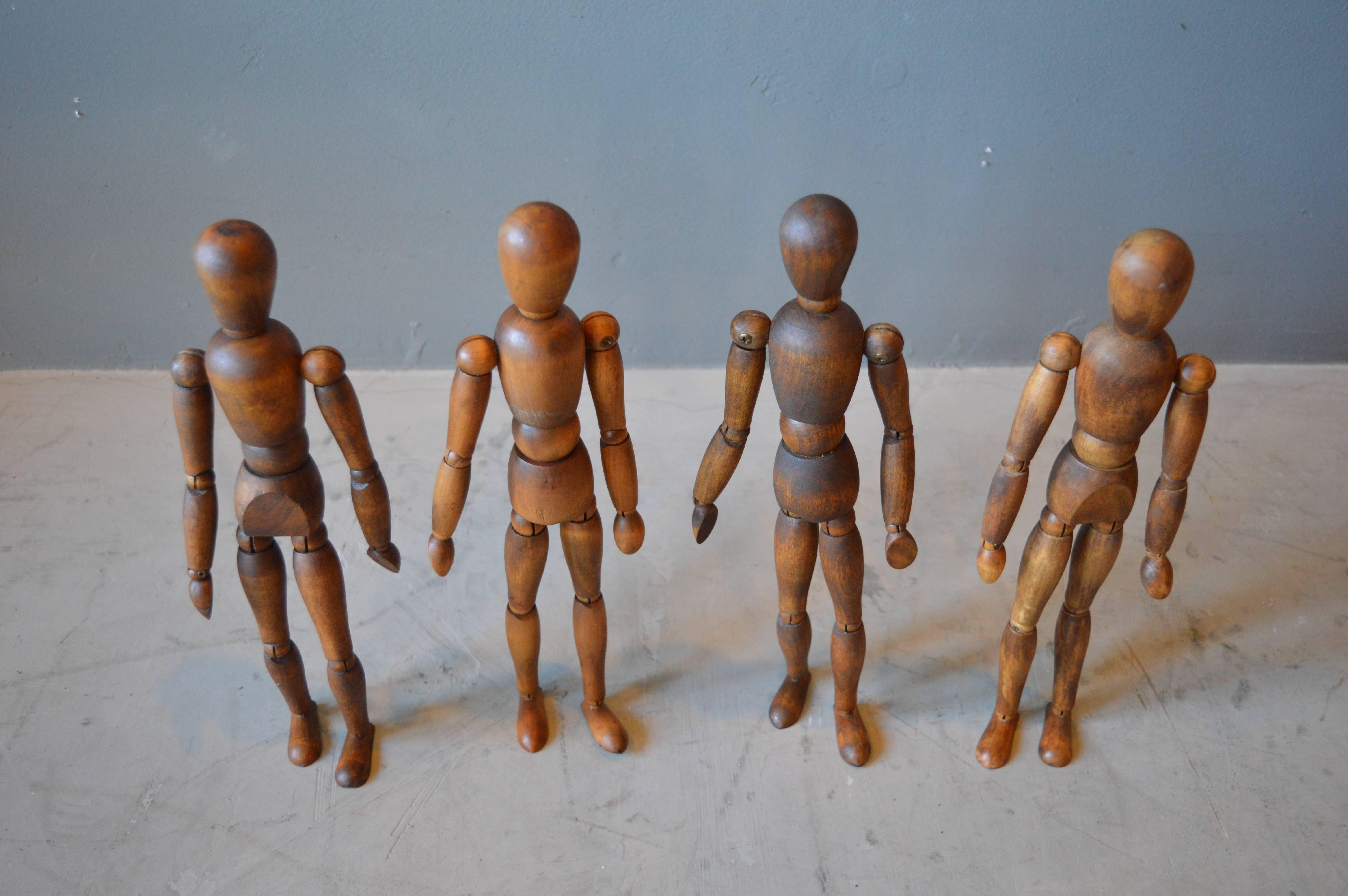Fantastic set of four vintage wood articulating artist models. Fantastic sculpture. Great age and coloring to the wood. Excellent vintage condition.

Massive two foot tall artist model available in separate listing.