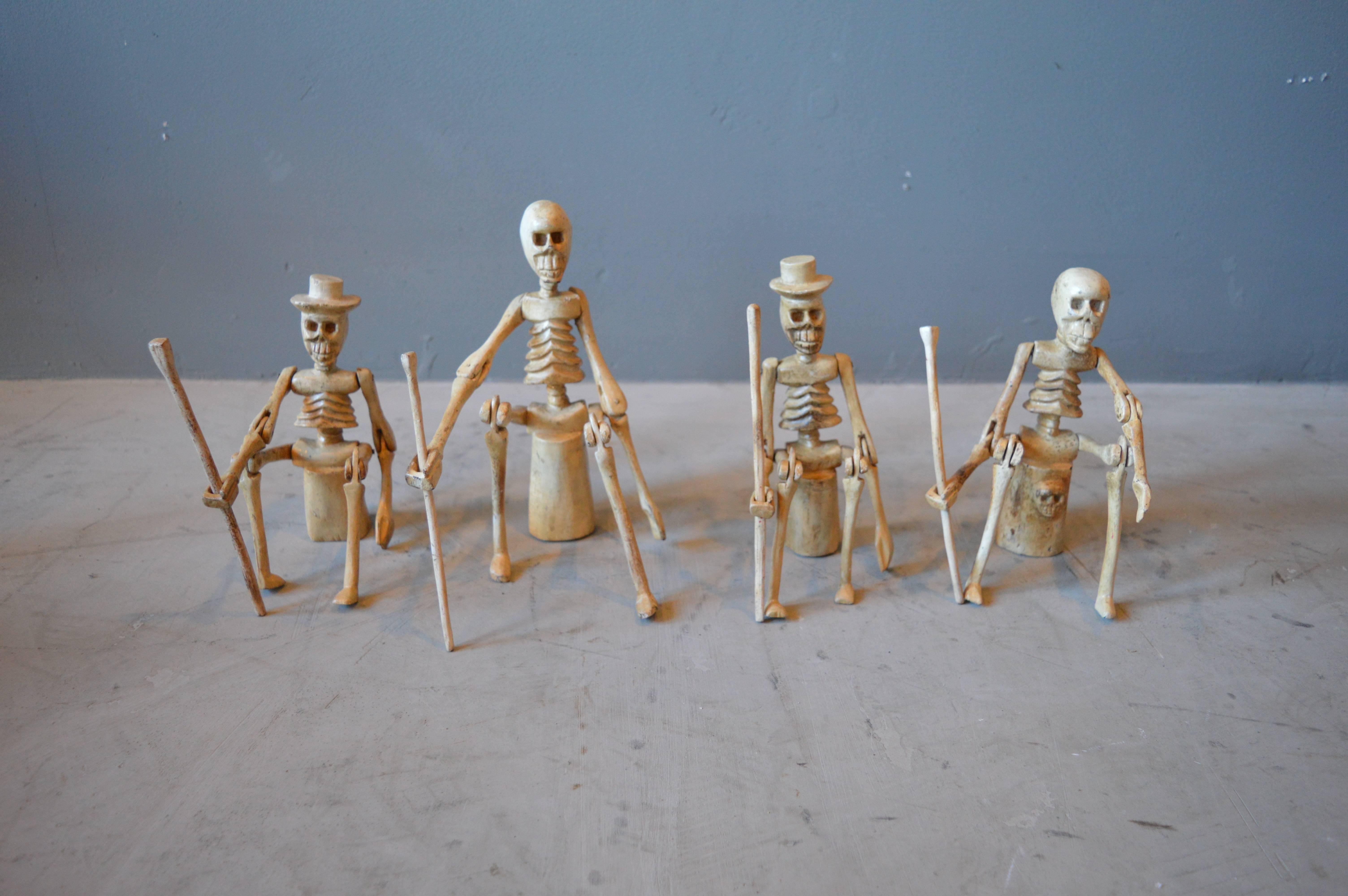 Interesting set of 4 articulating skeletons from South America. Arms and legs articulate. Each skeleton is holding a removable walking stick. Very cool set and sculpture. Excellent detail.

Each piece is roughly 6