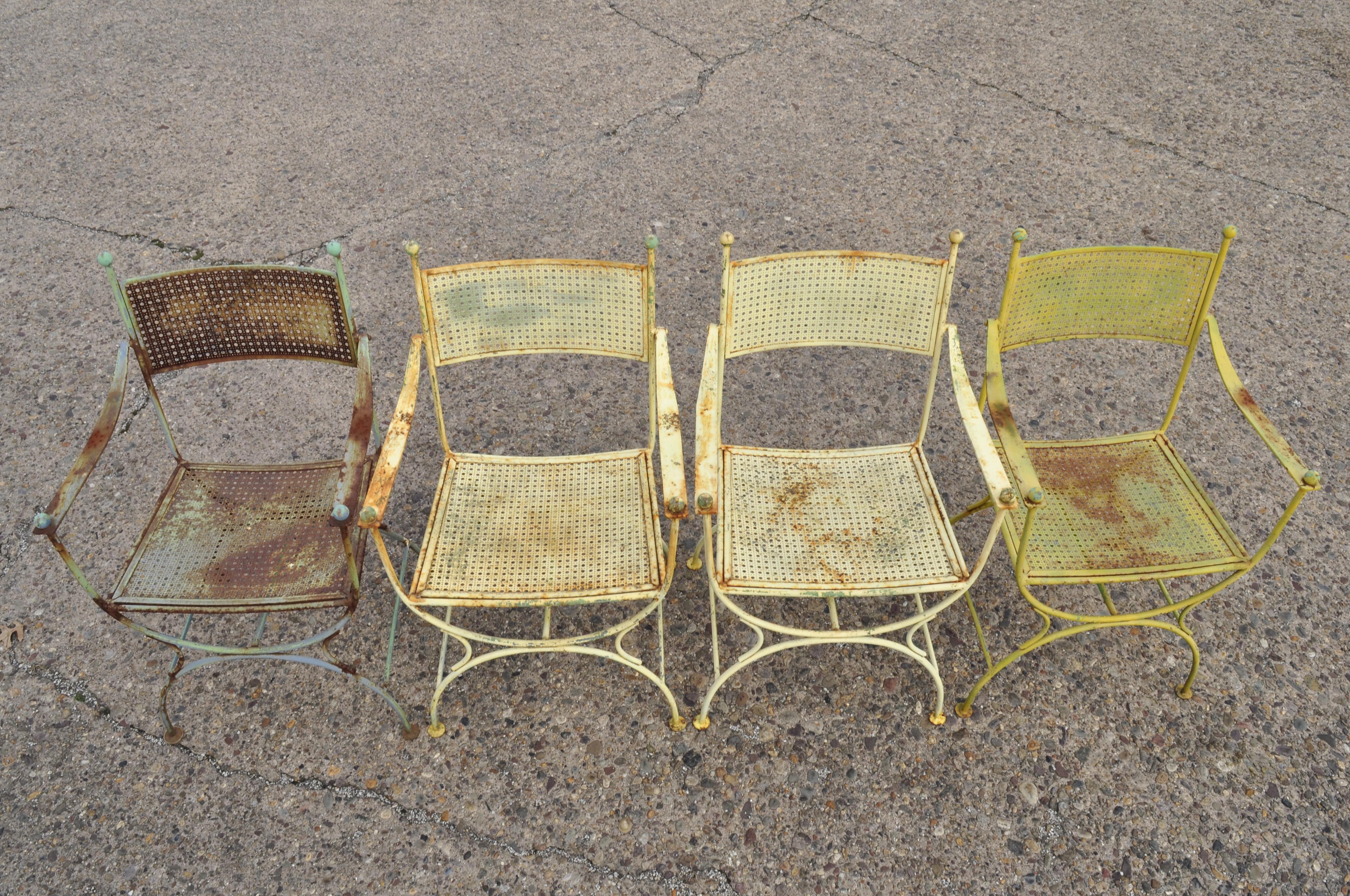 Set of 4 vintage wrought iron curule X-frame garden patio dining armchairs. Listing includes curule X-frame base, metal mesh seats and backs, (4) armchairs, wrought iron construction, very nice vintage item, great style and form, circa mid-20th