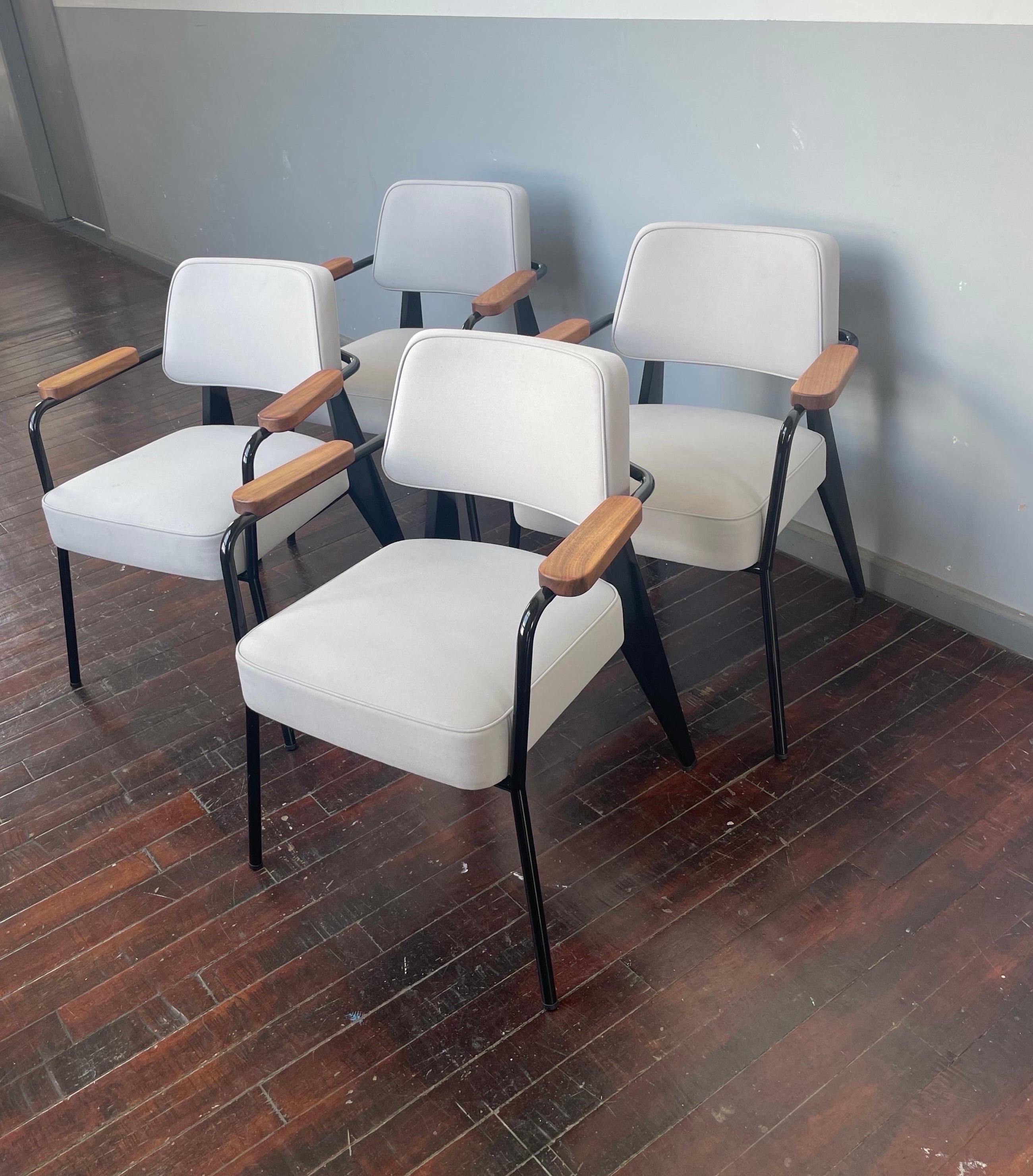 Originally designed by Jean Prouvé in 1939.

Set of 4 chairs in very good overall condition. These can also be sold as a set of two.

Light grey fabric. 

Extremely comfortable and supportive chair.

Can be used as a dining chair as well. Arm height
