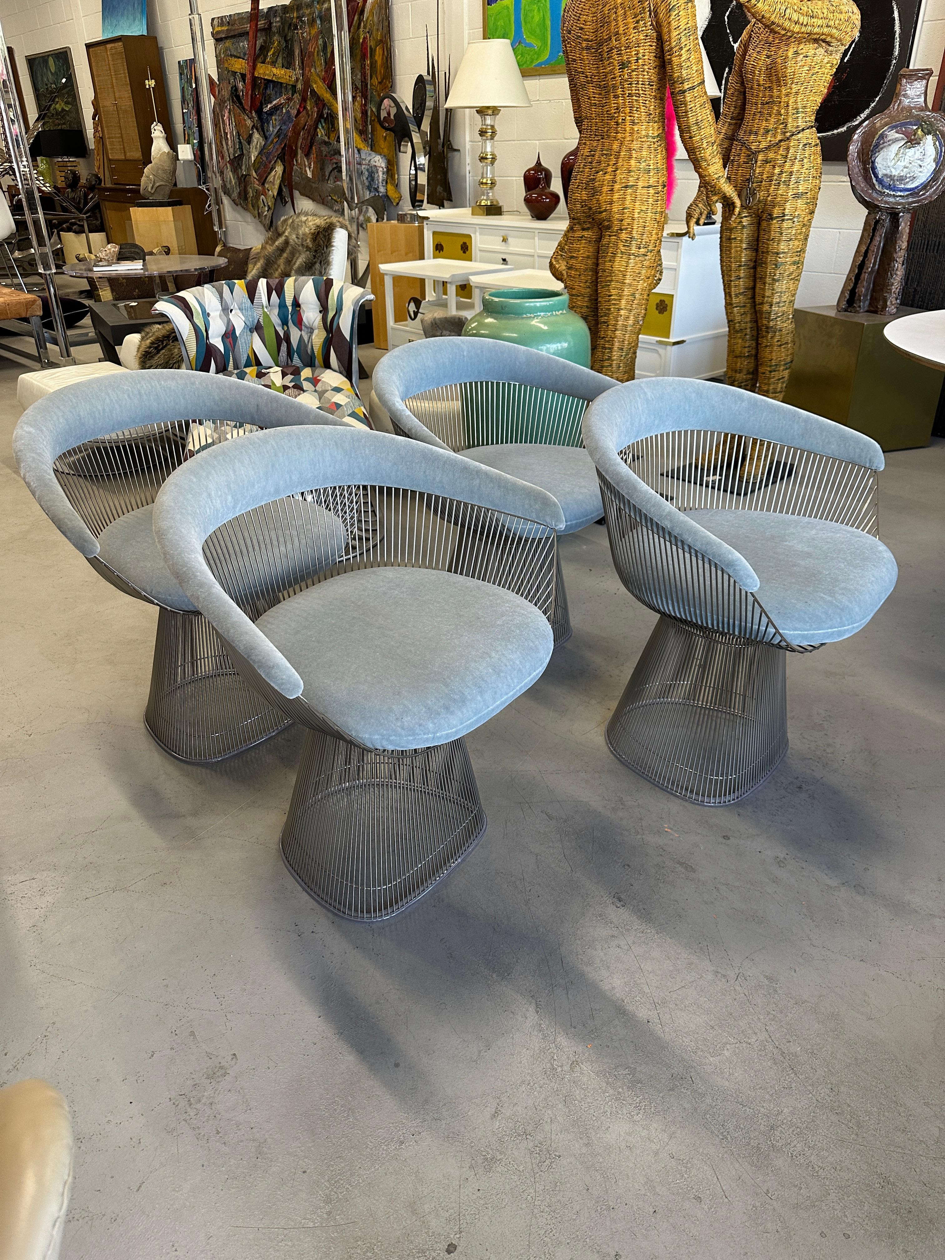 A set of 4 Warren Platner in polished Nickel I upholstered in Knoll Velvet in the color they call Swan I believe. The chairs are are marked with the Knoll K logo underneath the seat bottoms.  The nickel finish is in good condition on them with some