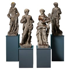 Lot de 4 statues en pierre reconstituée à l'aspect patiné représentant les arts