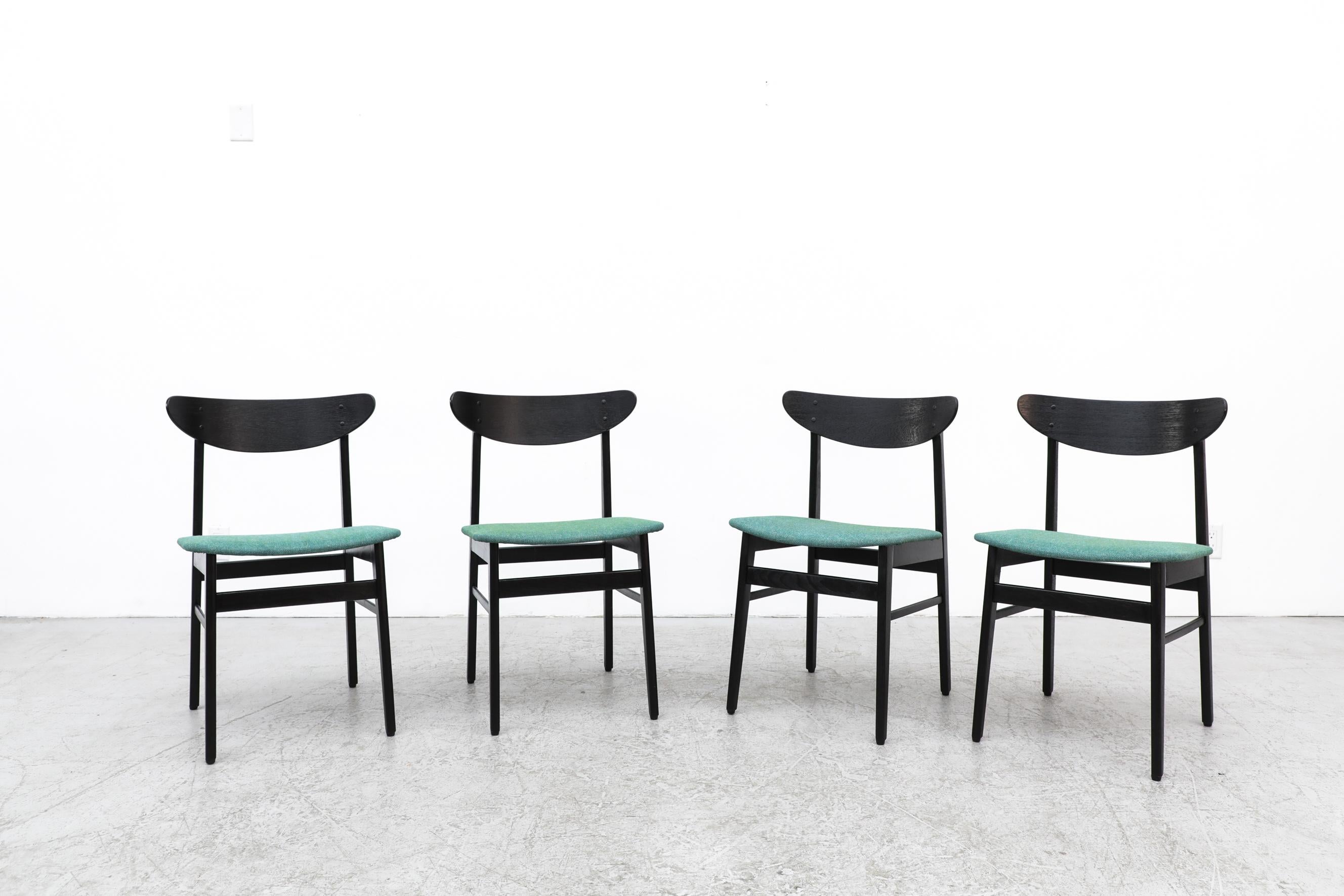 Set of 4 Wegner style black lacquered dining chairs by Farstrup. Almond shaped backrests and green upholstered seats make these comfortable as well as striking. In original condition with some light wear, consistent with their age and use.