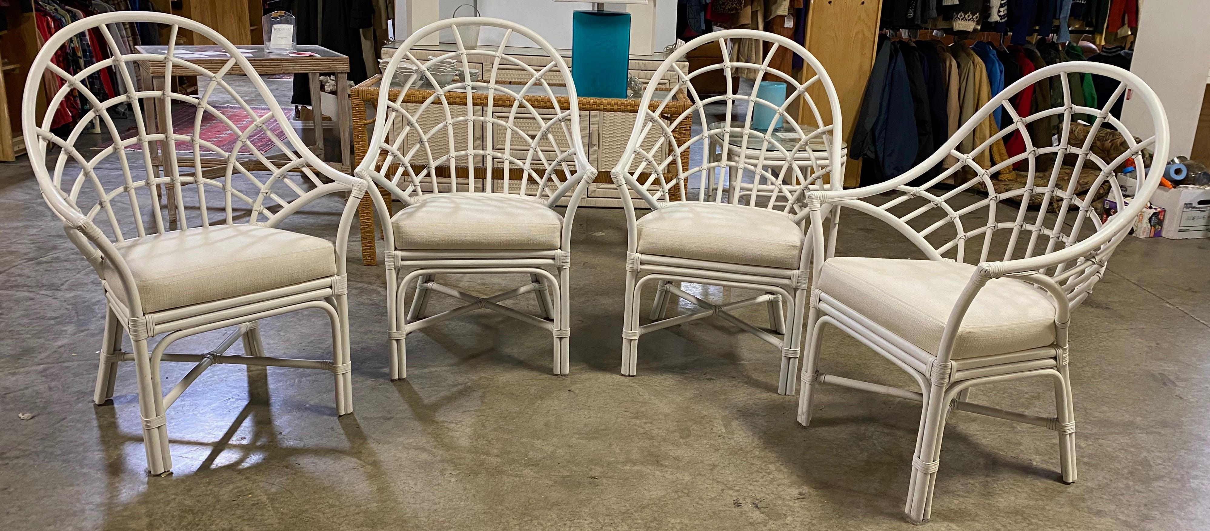 Add style and comfort to your dining experience with this set of 4 Mid-Century Modern Bohemian Chic rattan, wicker pencil reed fan back dining chairs. 
Use these high back white painted chairs on the porch or patio or a sun filled kitchen or dining