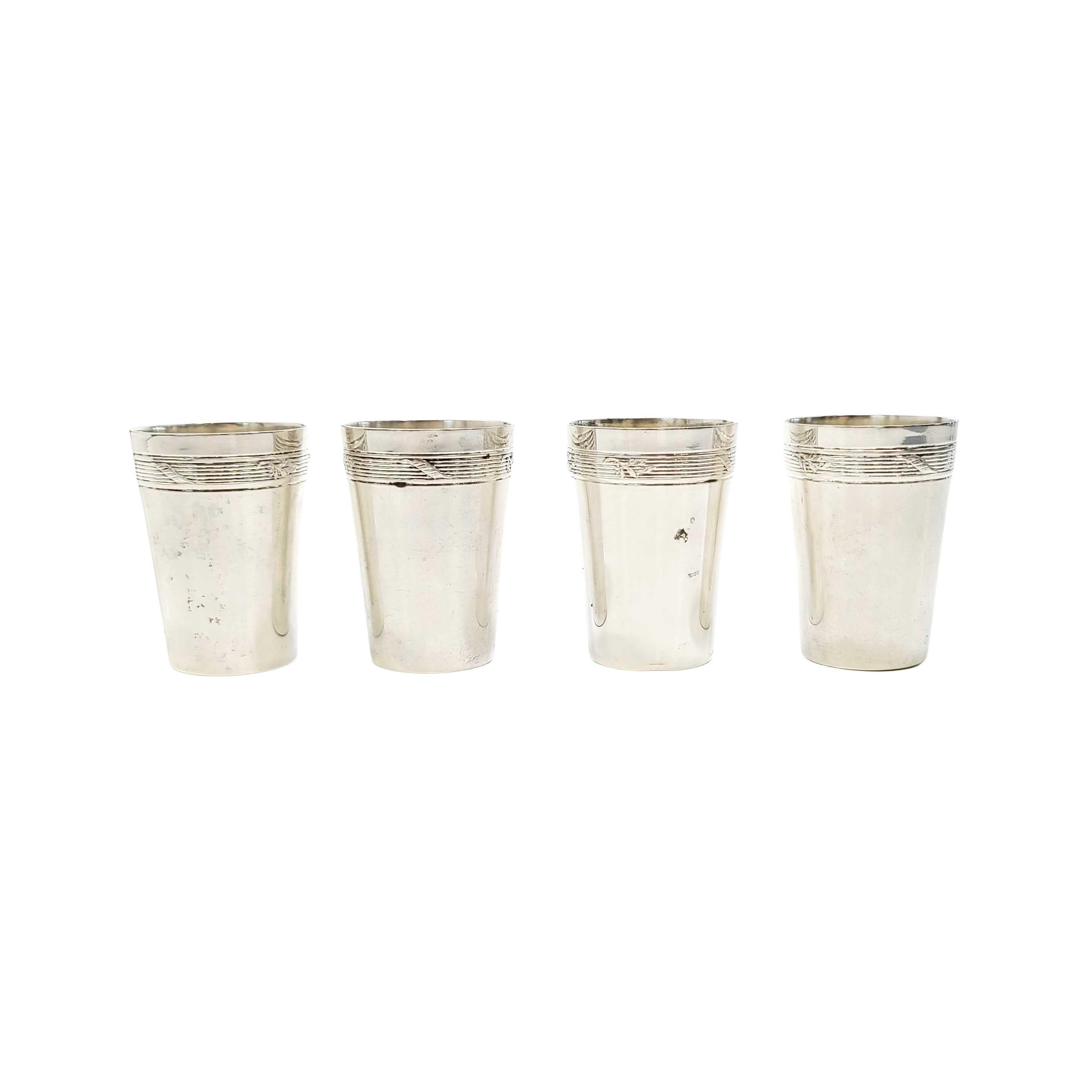 Set of 4 800 silver shot glasses by Wilhelm Binder for L. Bertsch.

These 4 small cups are polished smooth with a ribbed band with leaves around the top. Designed by Wilhelm Binder of Schwabisch Gmund, Germany.

Measures approx 1 5/8