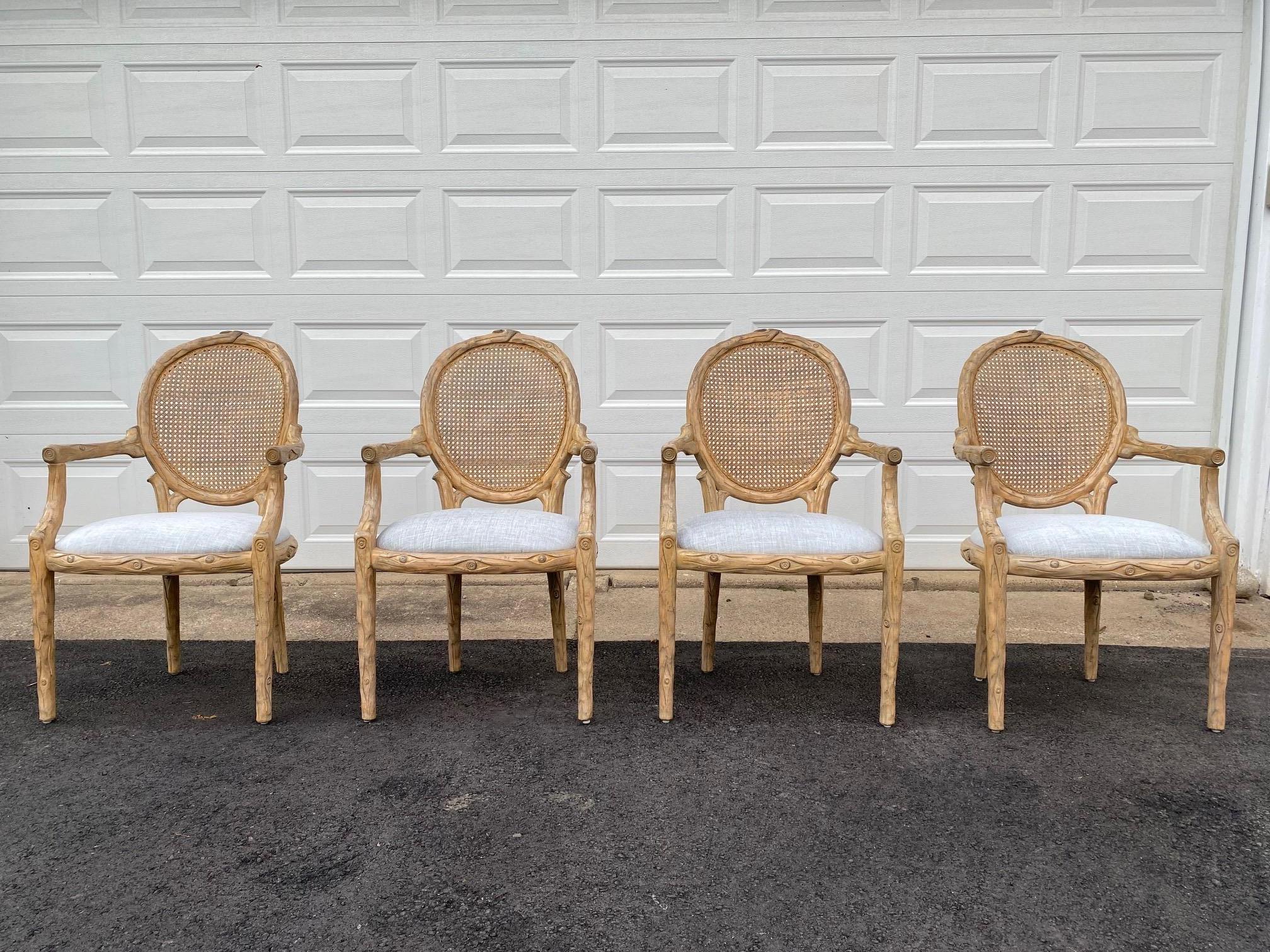  Stunning set of 4 natural light colored wood faux bois style dining arm chairs updated with new lush silver platinum chenille type neutral fabric. The caning is in excellent condition. Made by Peter Rocchia, The Wicker Works.

Arm Height: 27