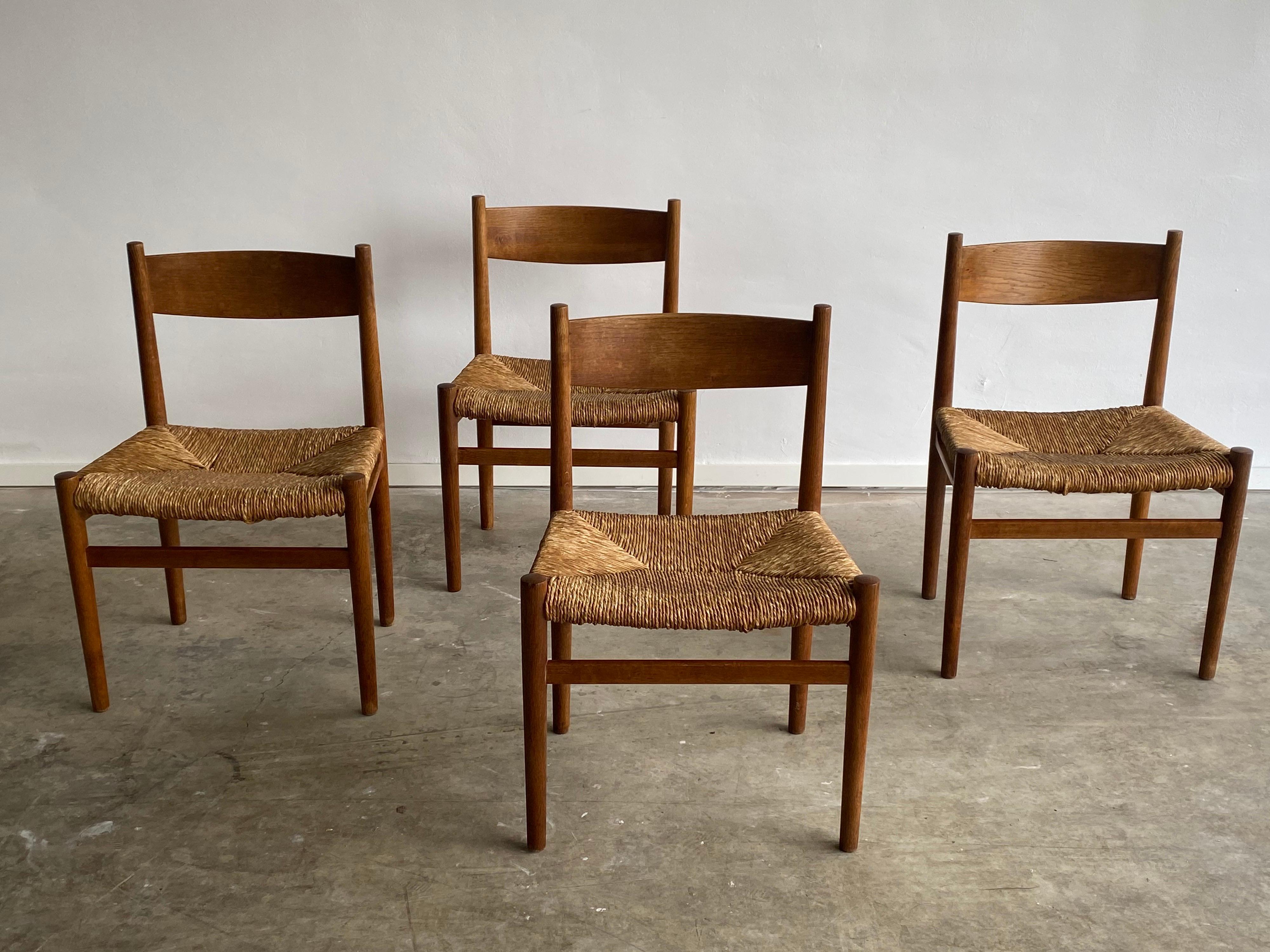 Set of four early mid-century dining chairs; much in the style of Hans Wegner and Børge Mogensen, Danish design. Quite rare because of their age and condition, the rush is still in good usable condition. At first glance the chairs seem very simple