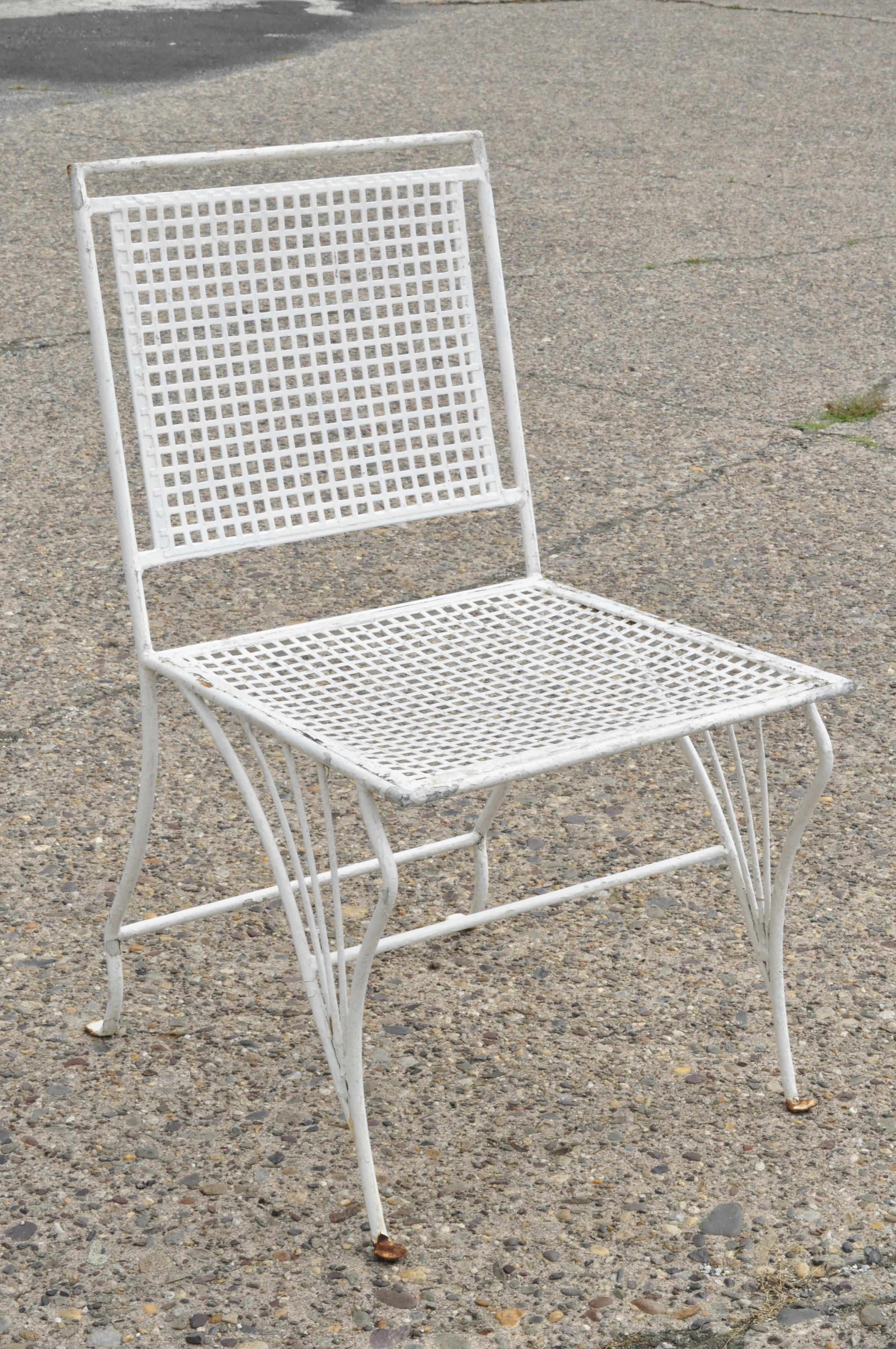 Set of 4 antique wrought iron Art Nouveau French style garden patio dining chairs. Item features sleek art nouveau legs, perforated back and seats, wrought iron construction, sleek sculptural form, circa mid-20th century. Measurements: 32