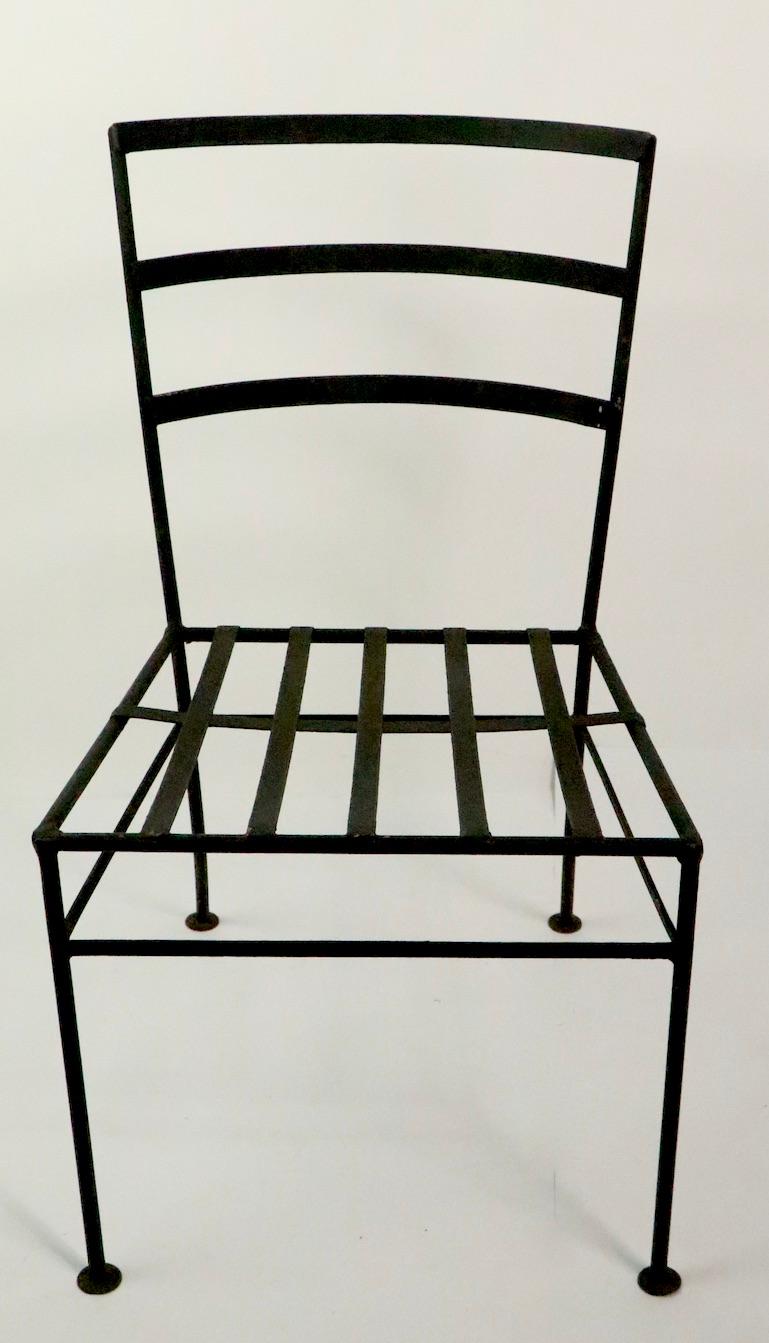 Set of four midcentury wrought iron dining height chairs in the style of George Nelson design for Arbuk. All four are in very good, original condition, clean and ready to use, showing only light cosmetic wear, normal and consistent with age.