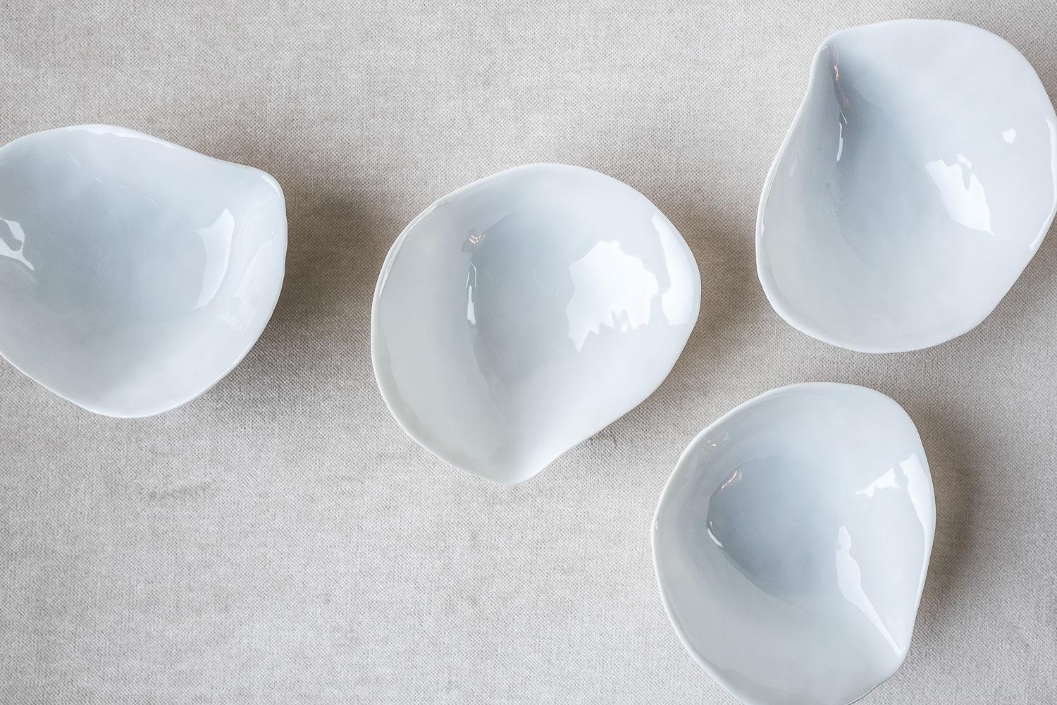 • Set of 4 small side bowls
• Measures: 10.5cm x 11cm x 4.7cm
• Perfect for a sexy amuse-bouche, a pre-dessert or side dish
• White glazed top, unglazed textured bottom
• Designed in Amsterdam / handmade in France
• True Porcelaine de