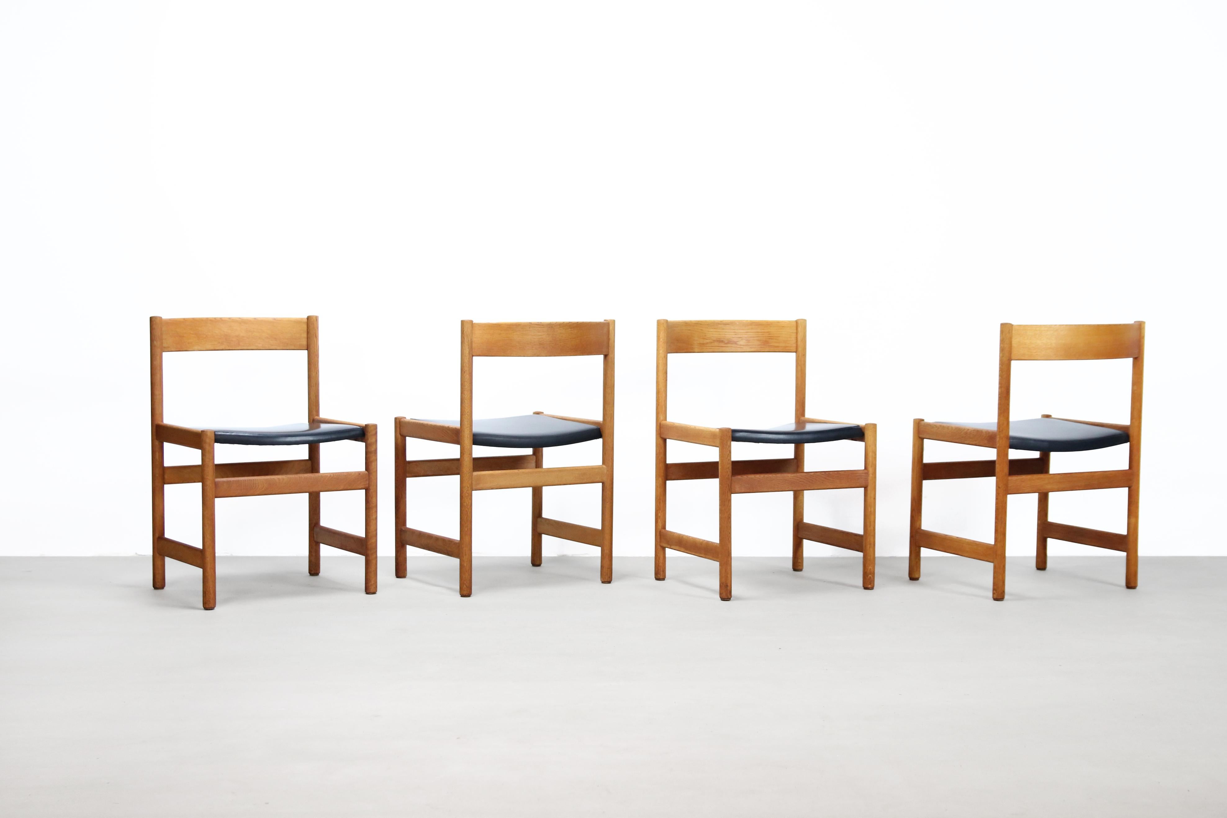 Beautiful set of four solid oak dining room chairs from the Triva series, designed by Yngvar Sandstrom from Sweden in the second half of the 20th century. The seats are upholstered in a black faux leather, which is very easy to clean. The woodwork