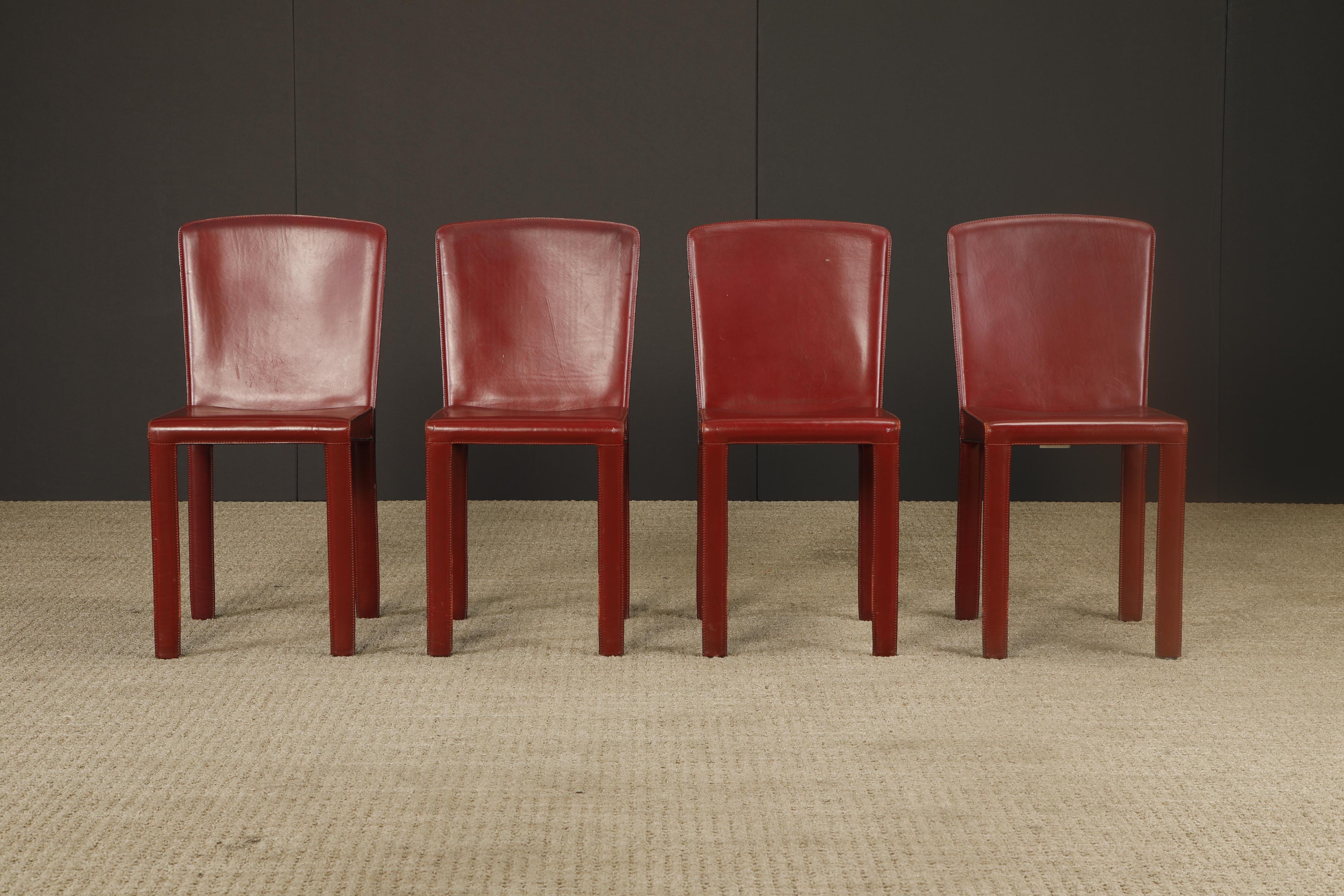 A handsome and well-crafted set of four dining chairs by Zanotta, Italy circa 1980s, in rich burgundy leather. Often compared stylistically to Mario Bellini’s iconic 'Cab' chairs for Cassina, these minimalist Italian chairs embody the same elegant
