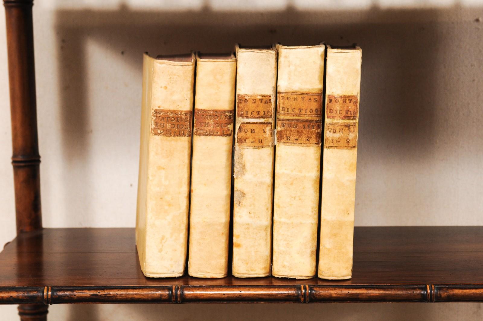 A handsome collection of 5 Italian 18th century vellum bound books. This set of religious/theological books from Italy, which retain their original vellum bindings, are dated from 1763 to 1768. The books seated side-by-side measure as an approximate