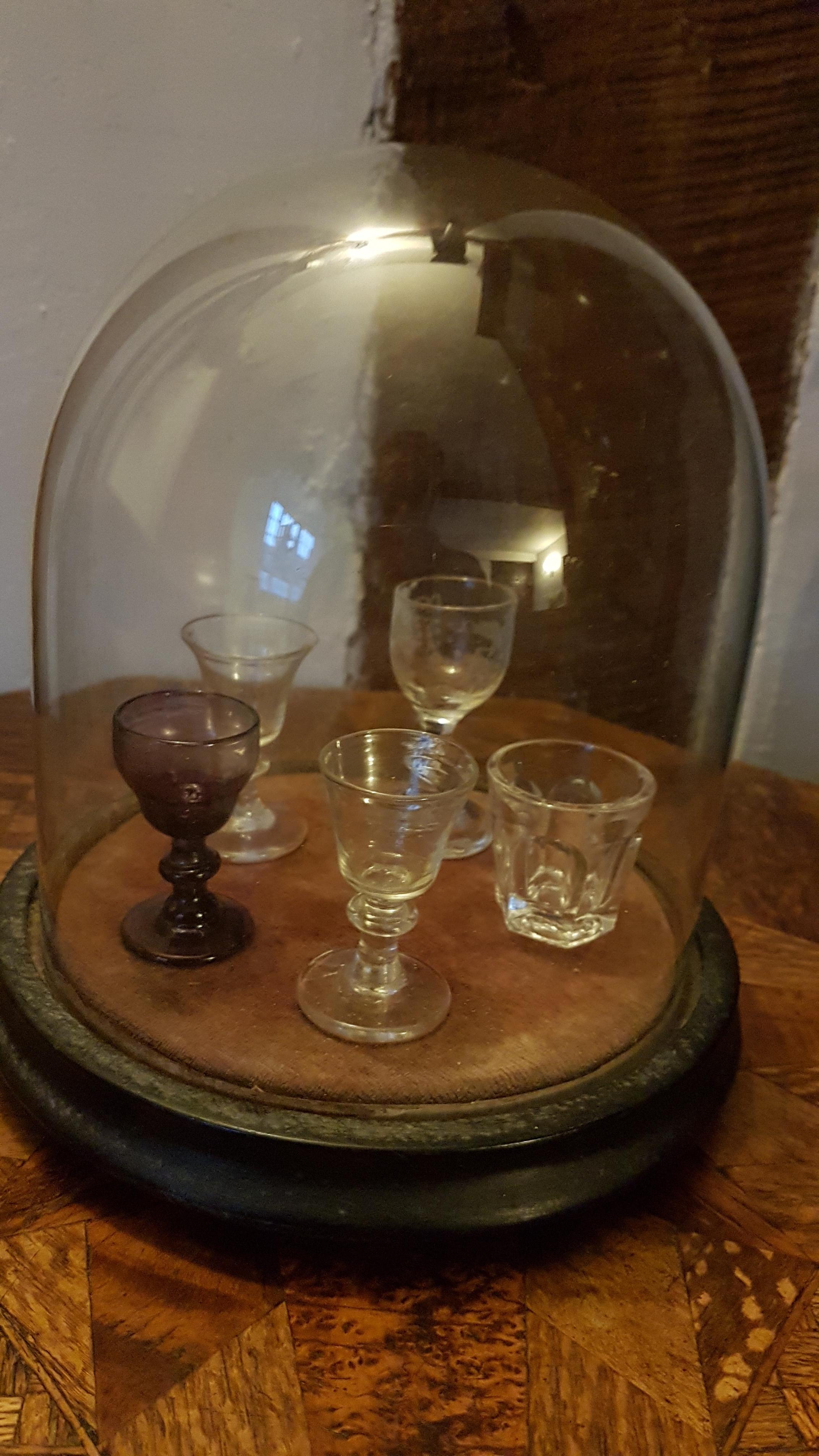 This is a very nice and quirky set of 5 different 19th century salesman sample glasses. One is a beautiful violet color with swirls in it. There is another that has grapes etched on it, one of a small tumbler (this one has a few small chips) the