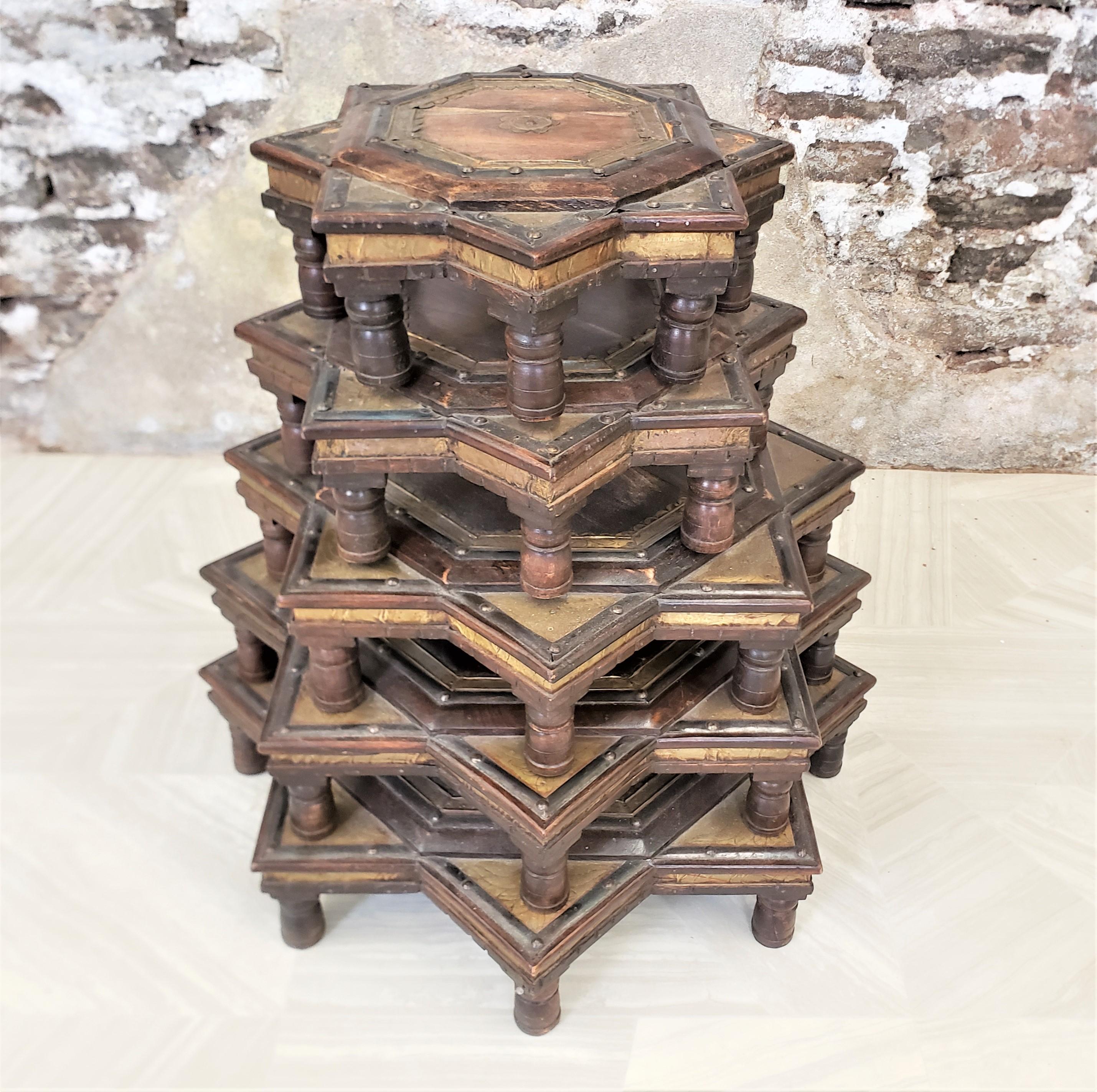 This set of five graduated stacking tables show no maker's marks, but are presumed to have originated from India and dating to approximately 1920 and done in an Anglo-Indian style. The tables are constructed of solid wood and done in a stylized star