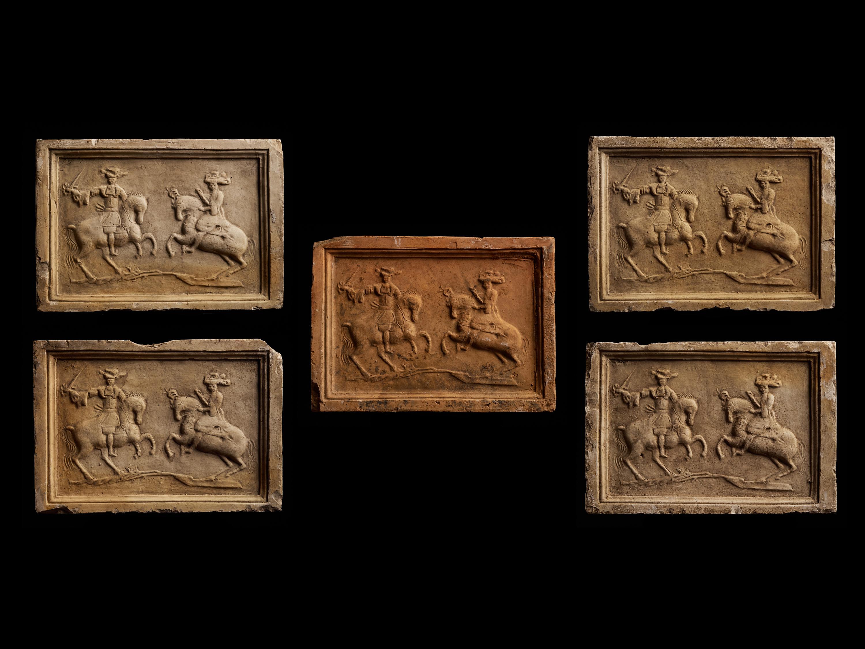 A set of 5 antique earthenware tiles with a relief of a duel with two figures on horses.