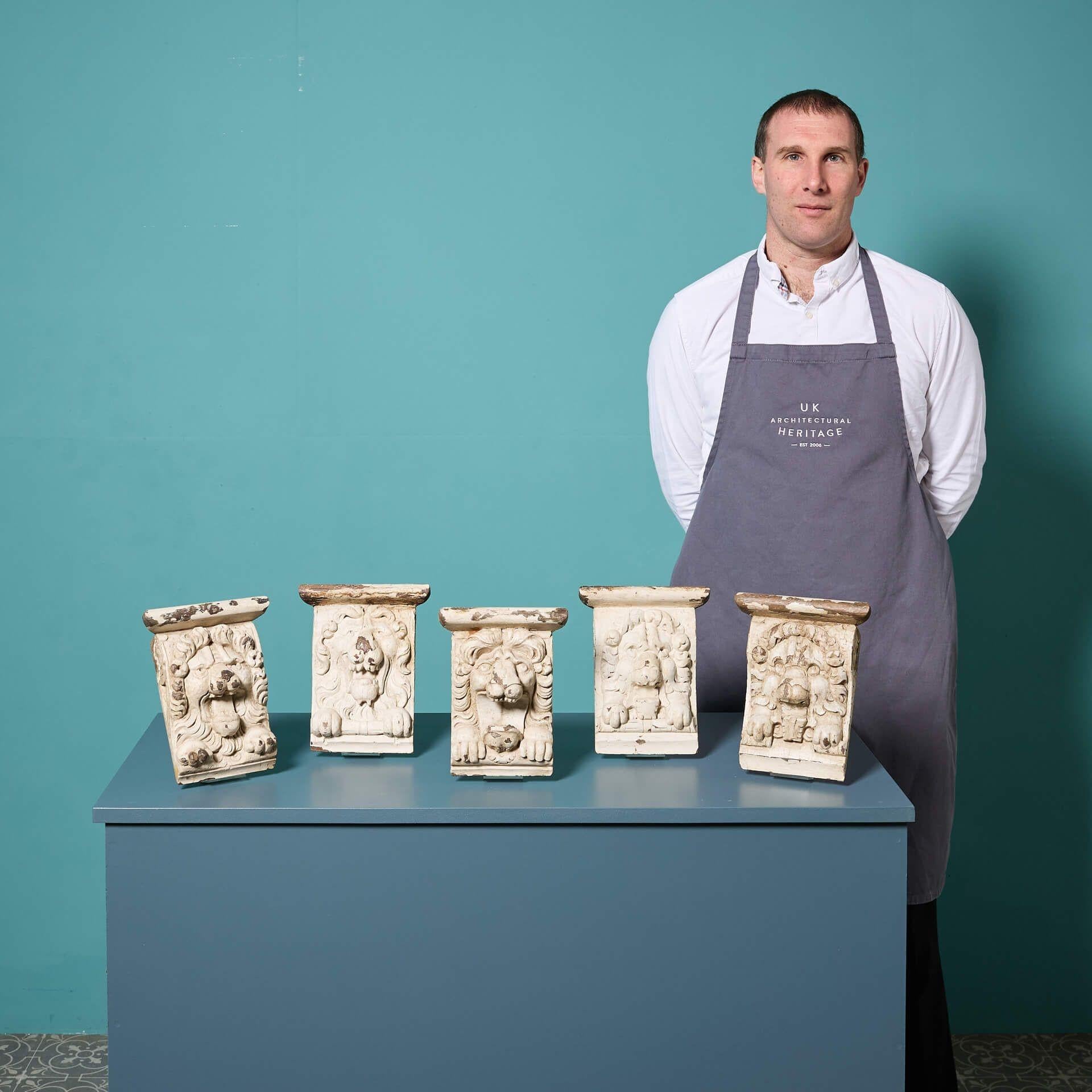 A set of five antique Georgian oak lion corbels sourced from Hassop Hall, Derbyshire.

Now an impressive interior feature, this set of decorative handcarved solid oak capitals are a fragment of architectural history, likely dating from the extensive