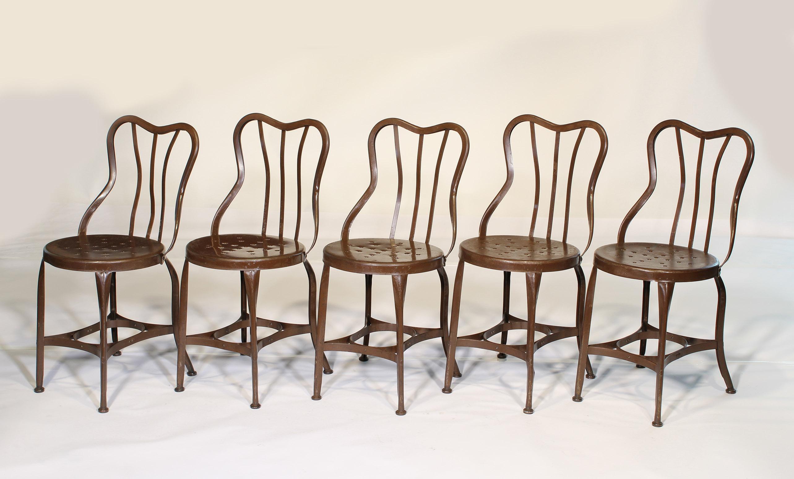 Authentic set of five 1920s steel cafe / ice cream chairs by Toledo. Distressed brown paint with gliders and sloped perforated seats. All chairs have been cleaned and checked for stability. Measurements: 31 7/8