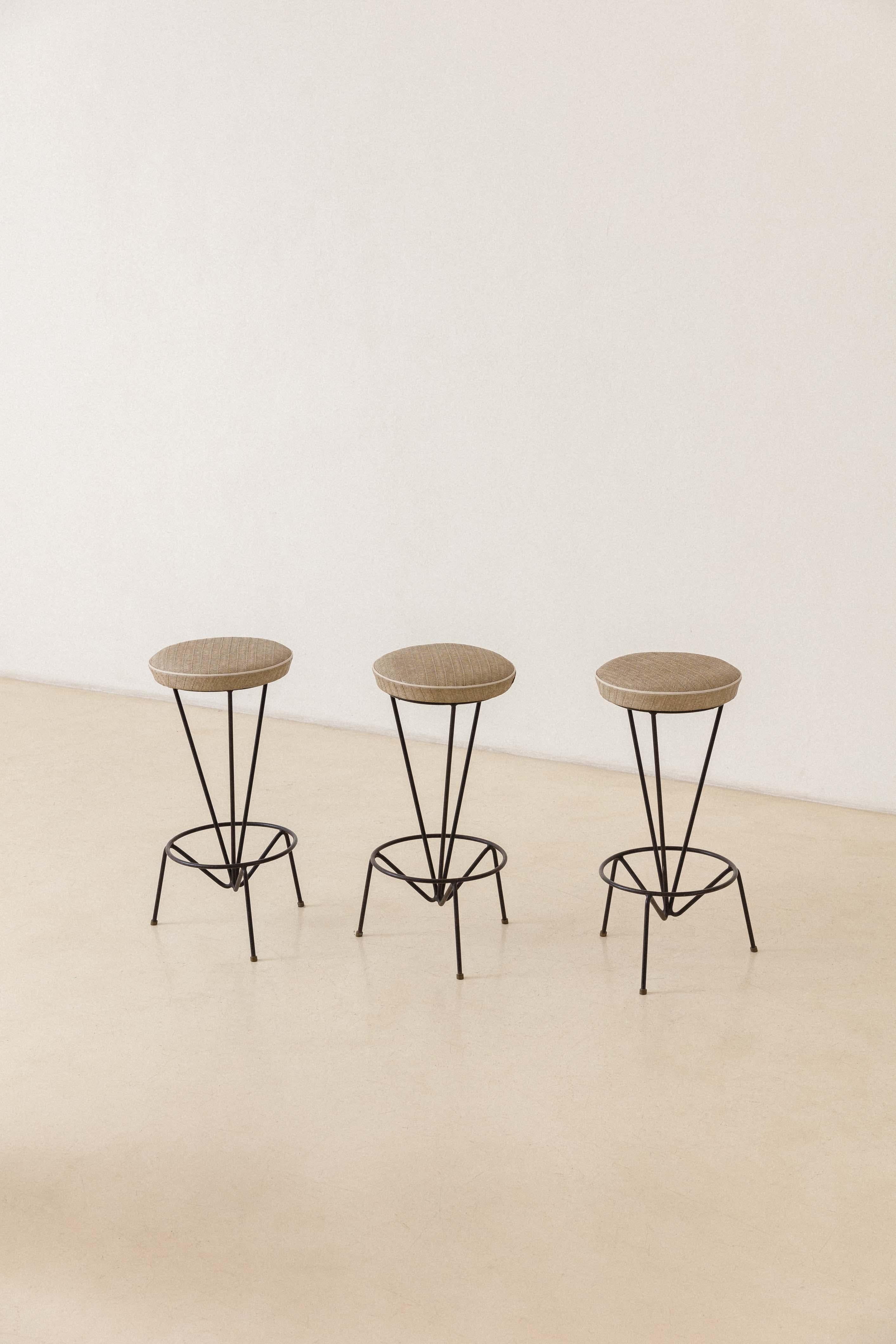 This fabulous high stool was designed by Martin Eisler and manufactured by Forma S.A. Móveis e Objetos de Arte in circa 1955. The piece is composed of an iron structure with brass tips with an upholstered seat. 

This particular design comprises