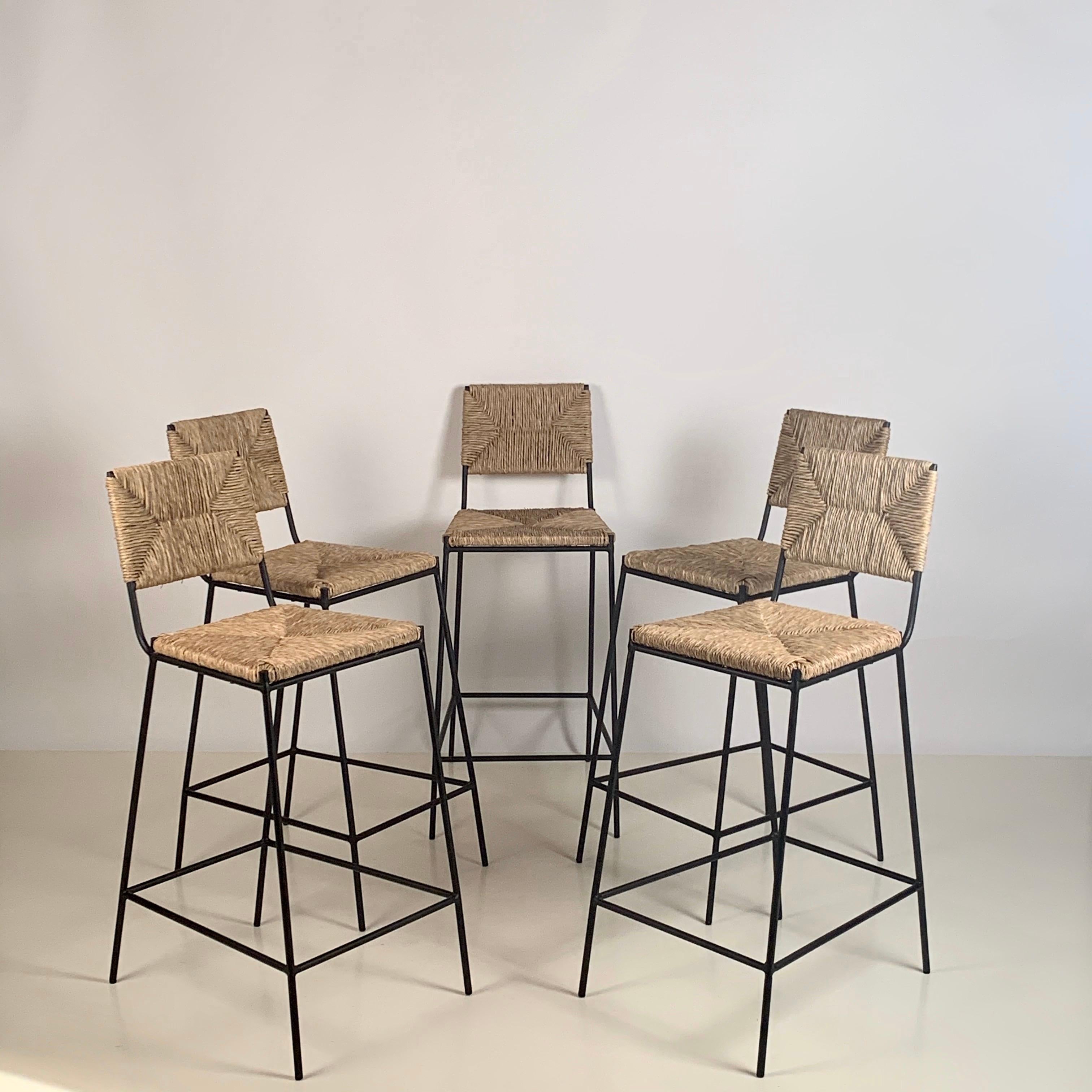 Set of 5 'Campagne' counter height stools by Design Frères.

Chic combination of slender but sturdy and stabile powder-coated steel frames with handwoven rush seats and backs. Extra support under the rush seat for durability. Durable plastic caps