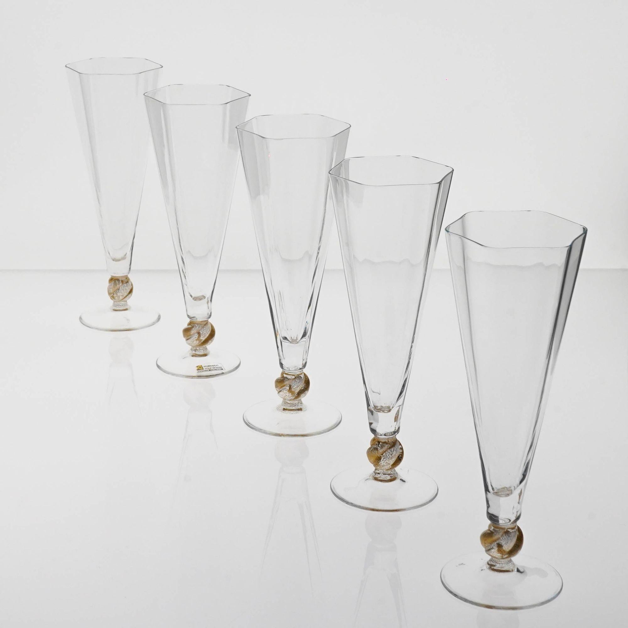 Cenedese Set of 5 flutes. Made by Maestri Muranesi, the company own by Amelio Cenedese working in the neverland of Murano.
It's the island of Serenella, made of the disposal of glass through the centuries. 
The flute is hexagonal, following the