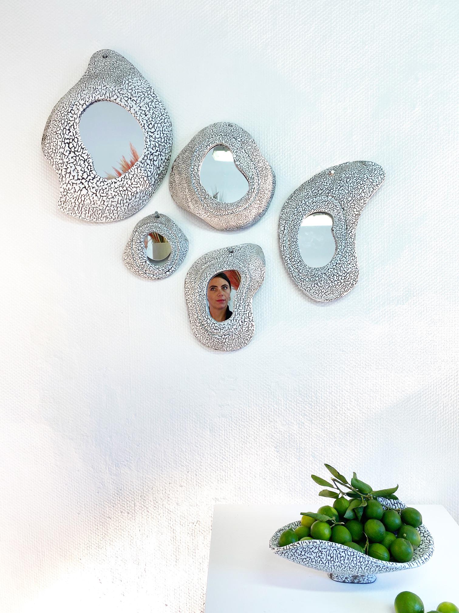 Set of 5 ceramic mirrors by Olivia Cognet
Materials: Ceramic 
Dimensions: Medium around 35-40 cm tall
 Large around 45-55 cm tall

  

Each of Olivia’s handmade creations is a unique work of art, the snapshot of a precious moment captured in