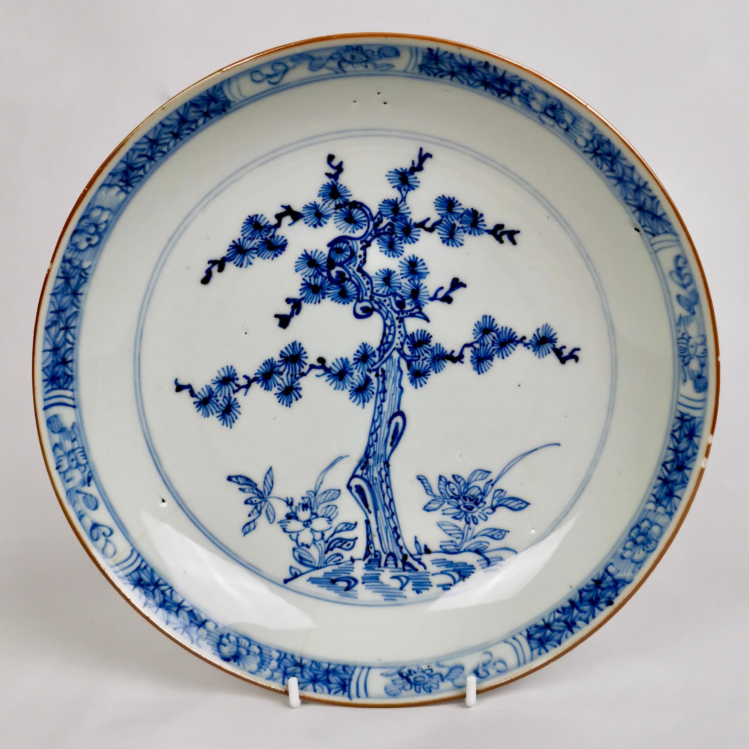 This is a beautiful set of five deep plates made in China for export to the West in the late Kangxi era, ca 1730.

The plates are very lightly potted in blueish glaze. The decoration was executed under the glaze in blue. All plates are beautifully