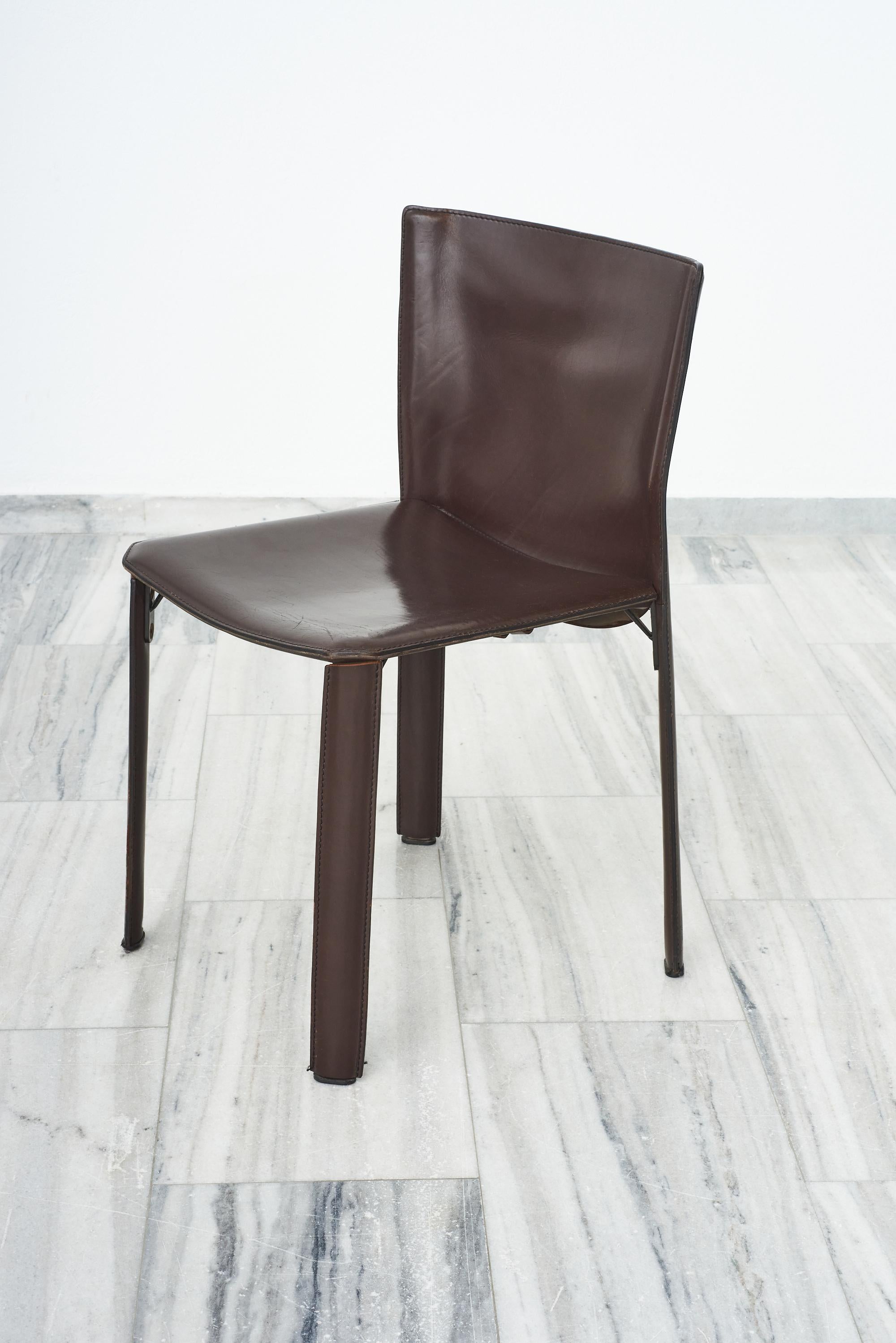 Set of 5 dark chocolate saddle leather dining chairs with leather straps under the seats.