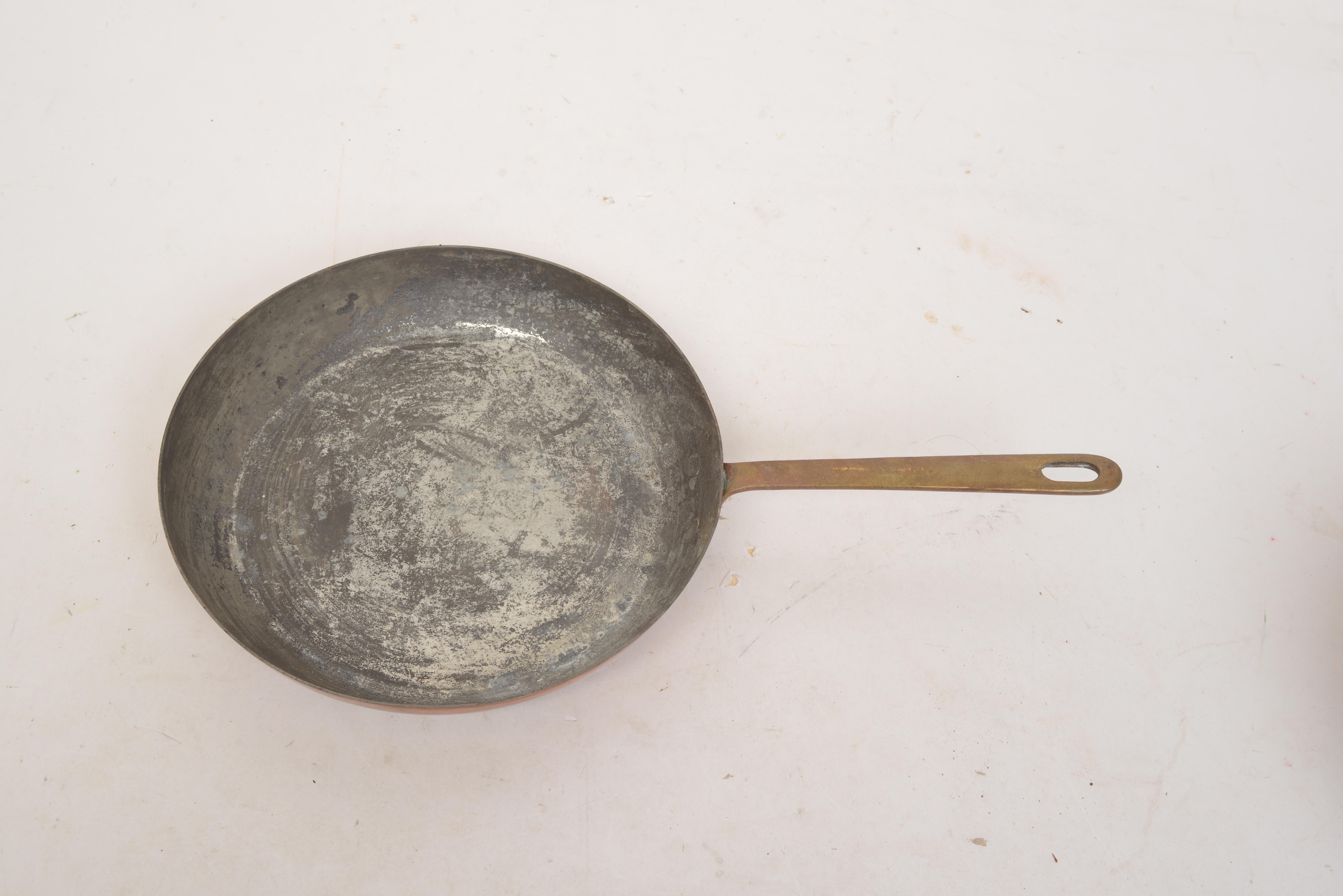 Set of 5 early copper pans, in original condition, Great patina, 18th/19th c. The pans all with traditional bronze or hand worked iron handles which are riveted on.
1. Deep sauce pan iron handle with hanging ring. 11