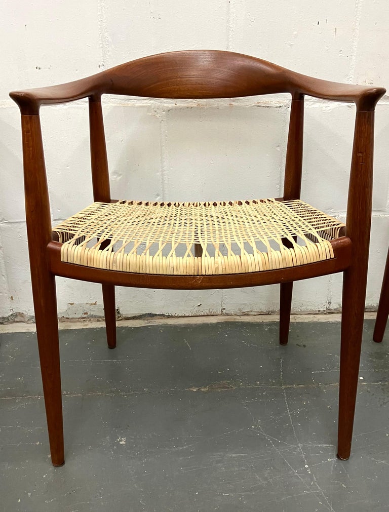 Classic set of JH-501 teak arm chairs with cane seats. This is an especially beautiiful and early set. The color of the wood and cane on the backs has aged so wonderfully that we have left it all original, beyond a light cleaning. The cane seats