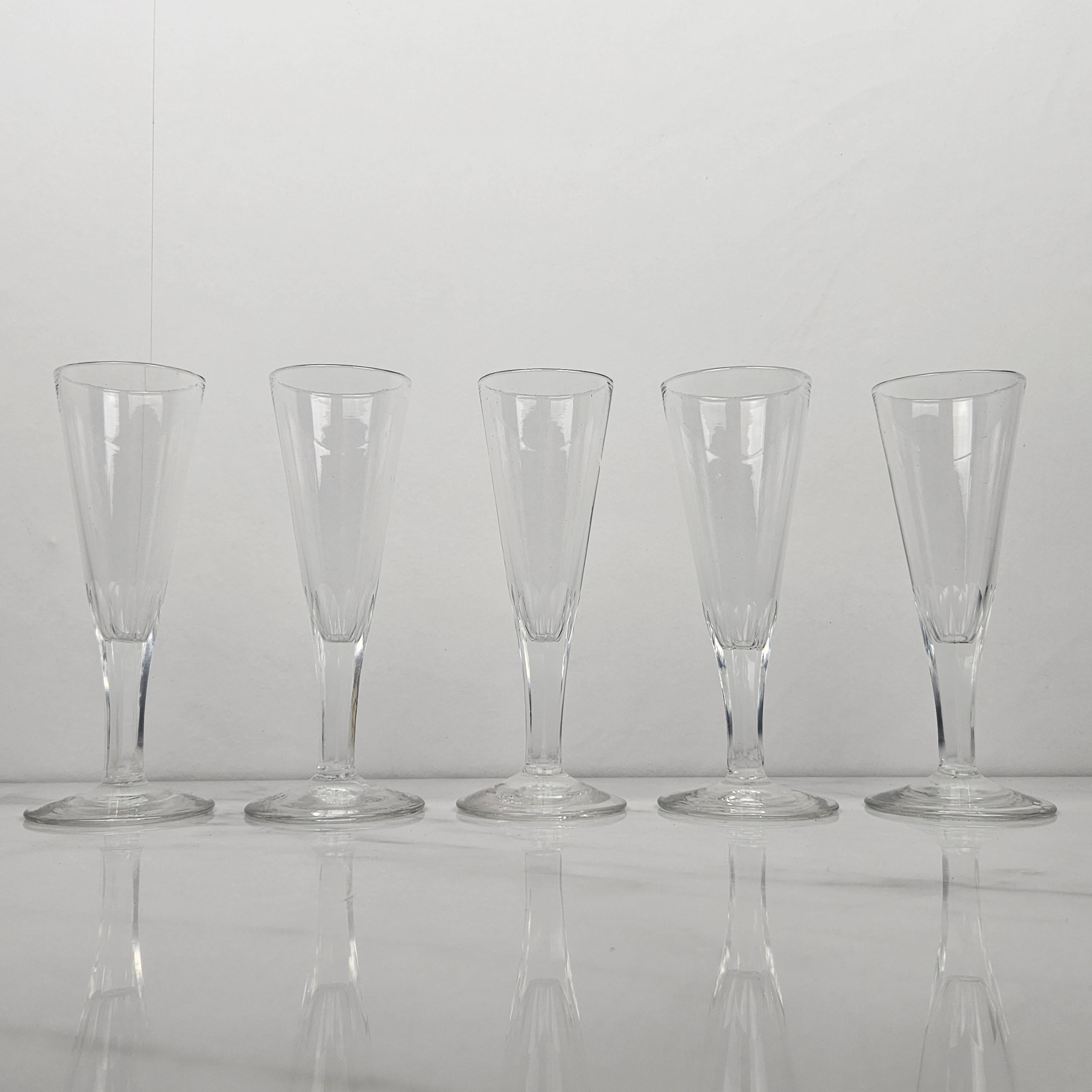 A beautiful set of five handmade French Champagne flutes in crystal glass, fabricated around 1830.  

These antique glasses are mouth-blown. 

Please take notice of the very nice details and the elegant design.
Meticulously handcrafted, these