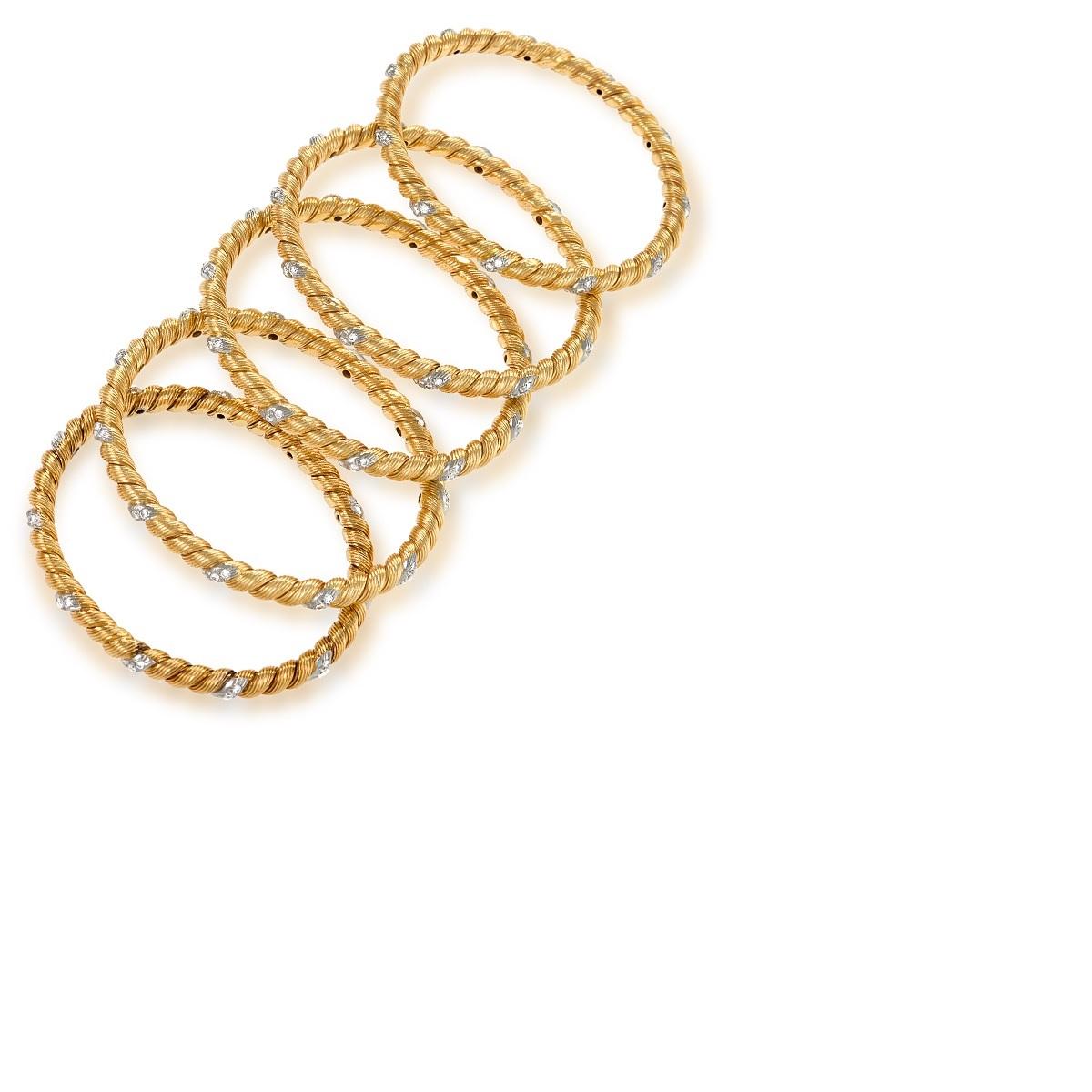 A set of five French 18 karat gold and platinum bangle bracelets with diamonds by Van Cleef & Arpels. The bangle bracelets have 165 diamonds that have the approximate total weight of 5,50 cts. Circa 1970's.

Signed, VCA France 2V89272 750. 